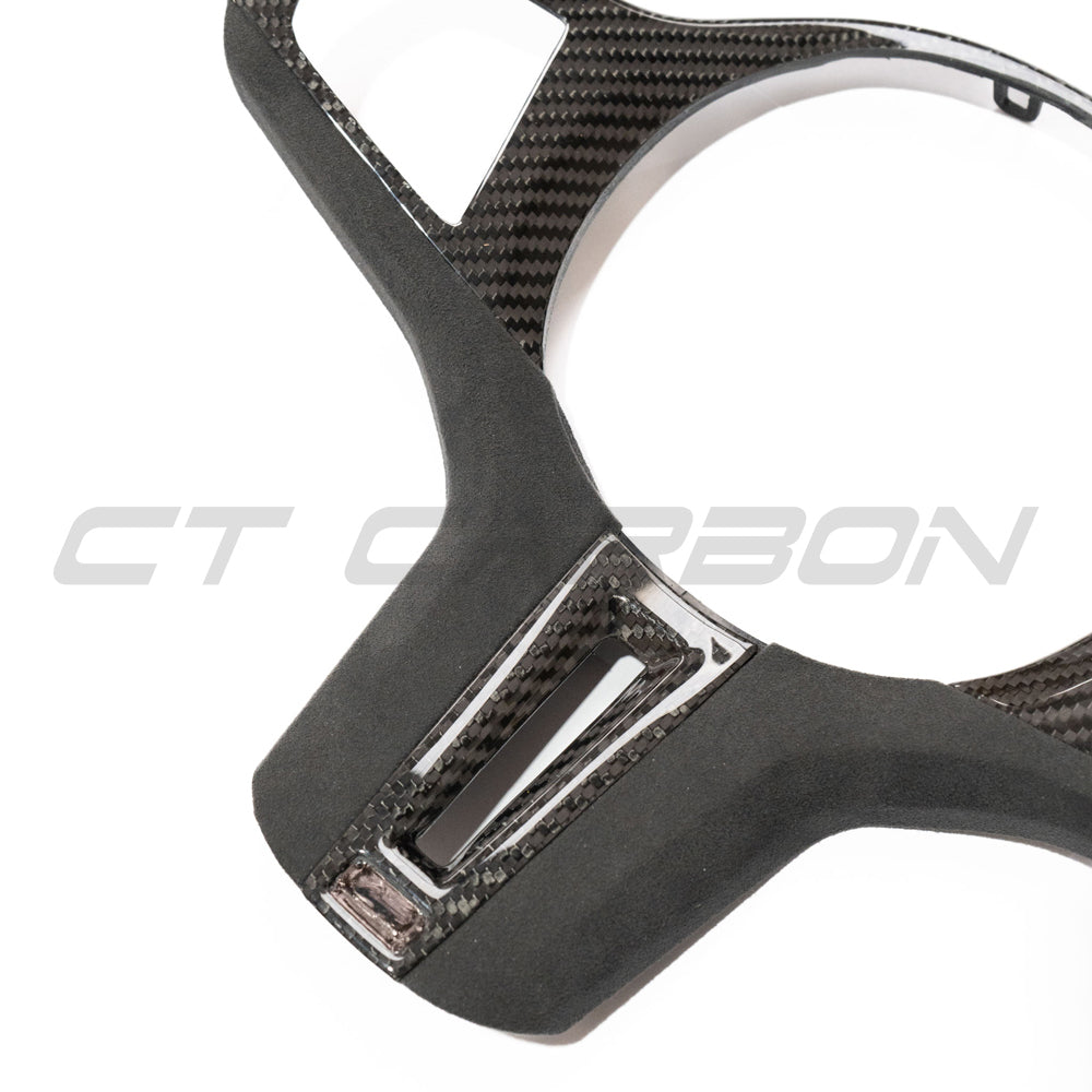 BMW Gxx M carbon fiber steering wheel trim accessory by CT Carbon, featuring a sleek, lightweight design for a sporty interior upgrade.