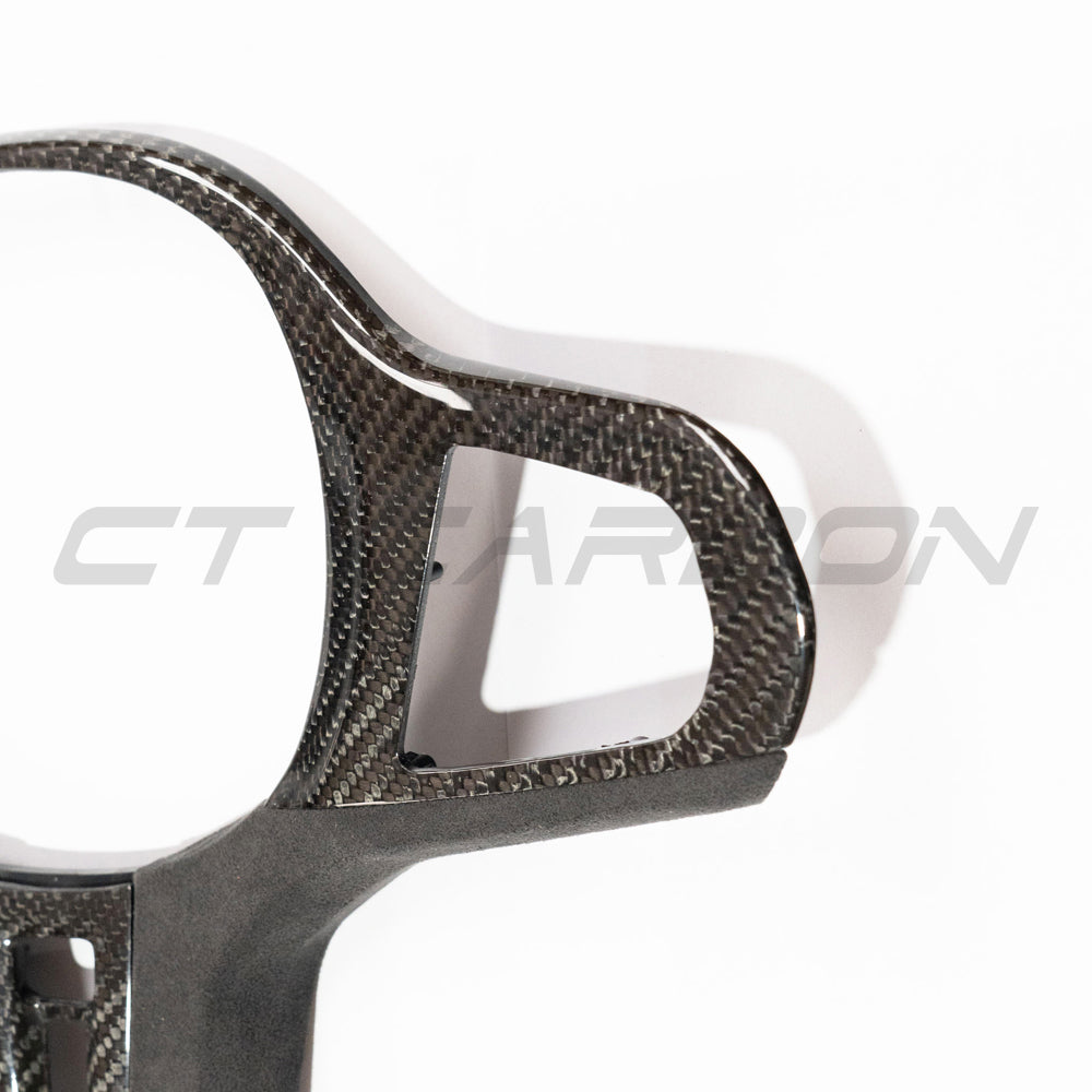 BMW Gxx M car carbon fibre steering wheel trim with heating feature, designed by CT Carbon for enhanced interior style.