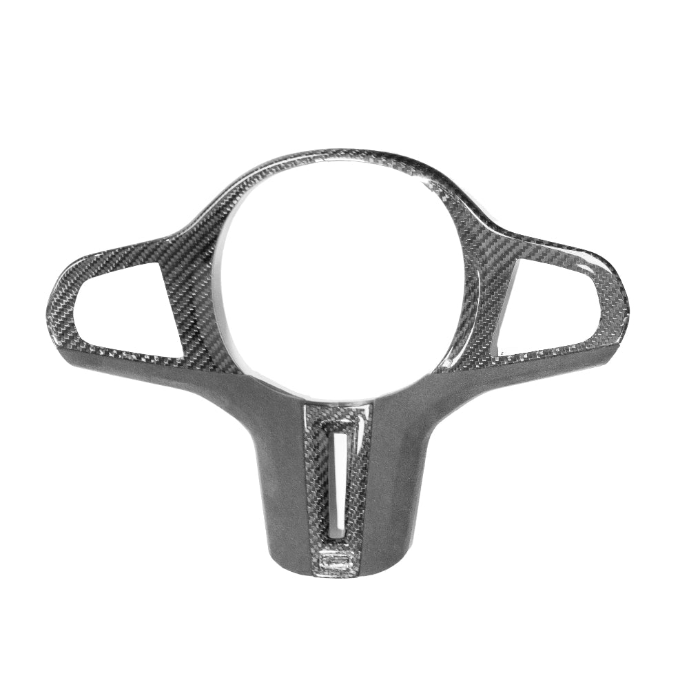 BMW Gxx M carbon fibre steering wheel trim accessory by CT Carbon, showing close-up of sleek black carbon fibre surface.
