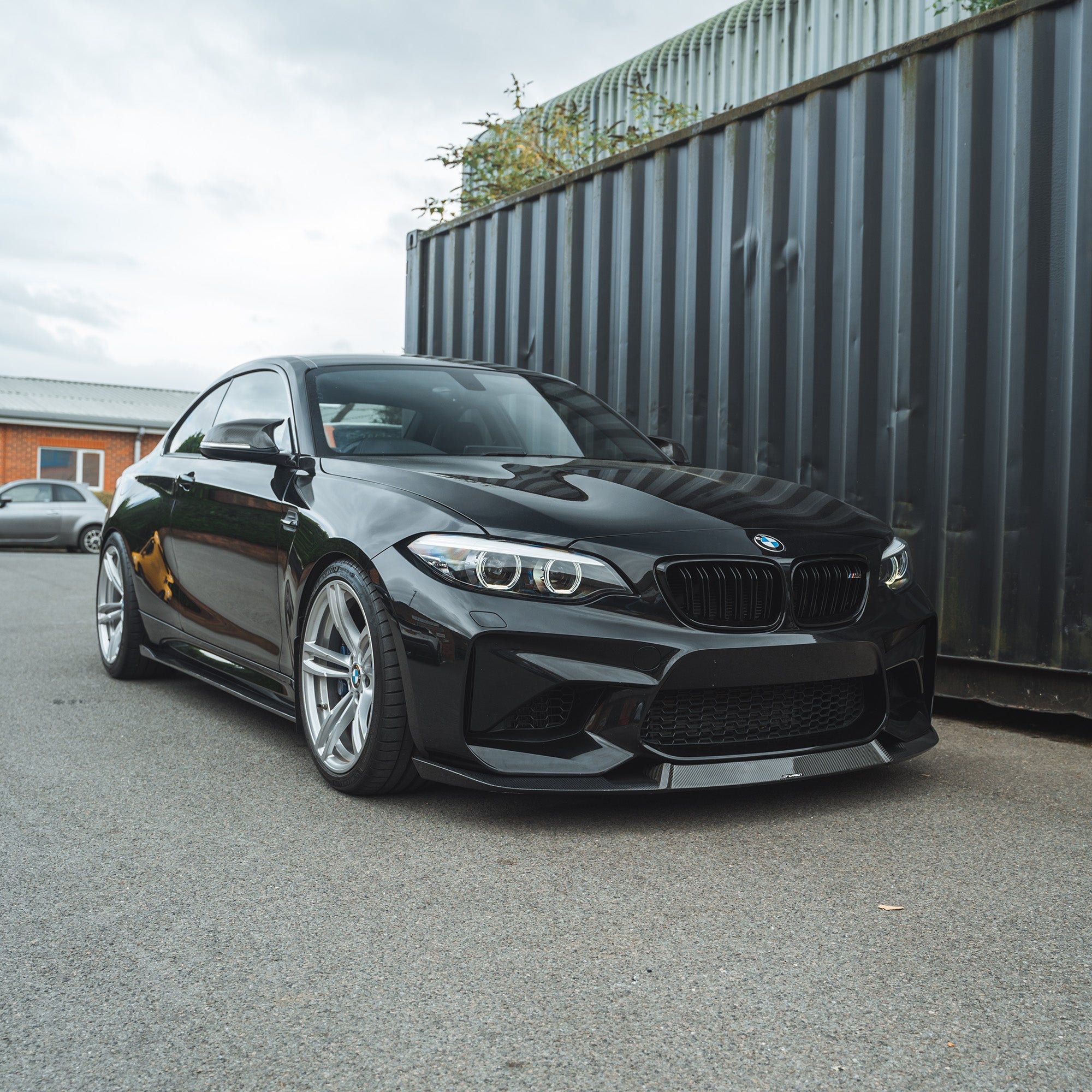 BMW M2 F87 N55 2015-2017 carbon fiber splitter by CT Carbon, styled like M4 CS, installed on the front of the sports car.