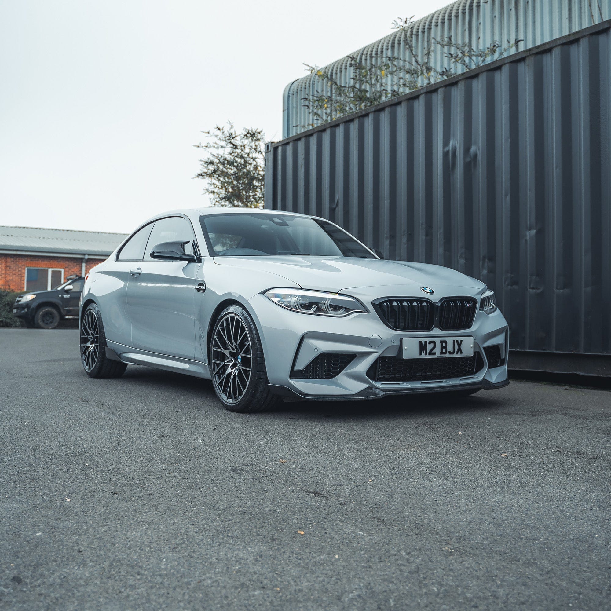 BMW M2 F87 carbon fibre side vents by CT Carbon, showcasing sleek, lightweight accessory details on the car's side panel.