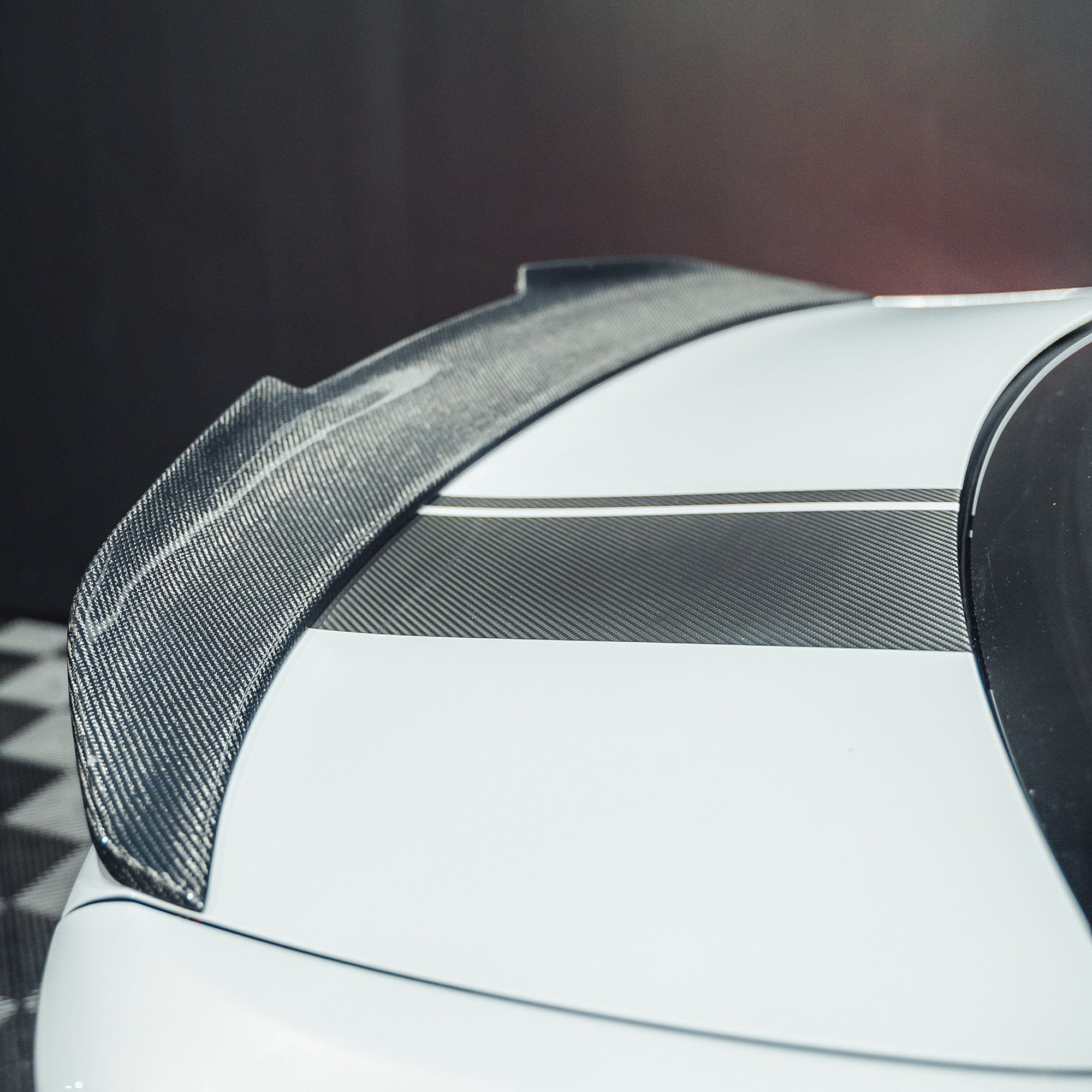 BMW M2 F87 and F22 carbon fibre ducktail spoiler by CT Carbon, showcasing sleek aerodynamic design on the car's rear.