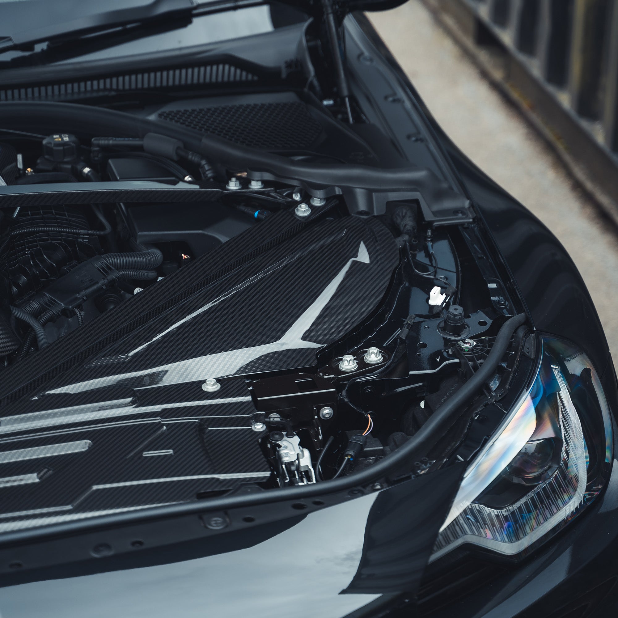 BMW M2, M3, M4 G87, G80, G81, G82, G83 carbon fibre air intake cover by CT Carbon, close-up view of the sleek accessory.