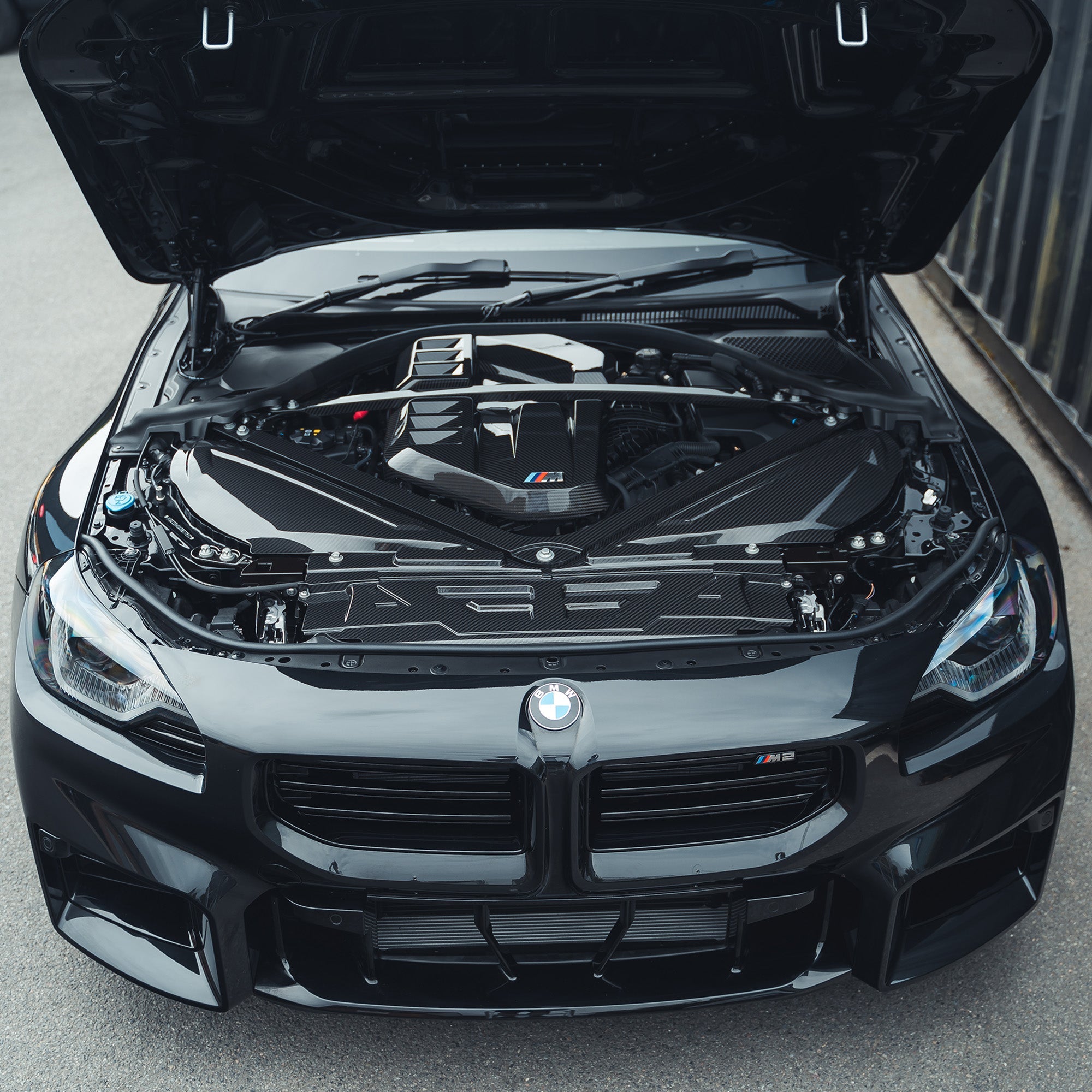 BMW M2 M3 M4 G87 G80 G81 G82 G83 carbon fiber air intake cover by CT Carbon, showcasing sleek, lightweight engine accessory.
