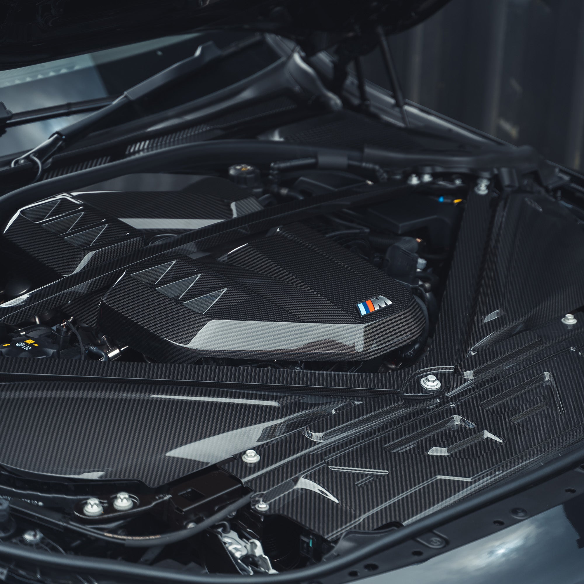 BMW M2, M3, M4 G87, G80, G81, G82, G83 Carbon Fibre Engine Dress Up Kit by CT Carbon, showing sleek carbon fiber parts.