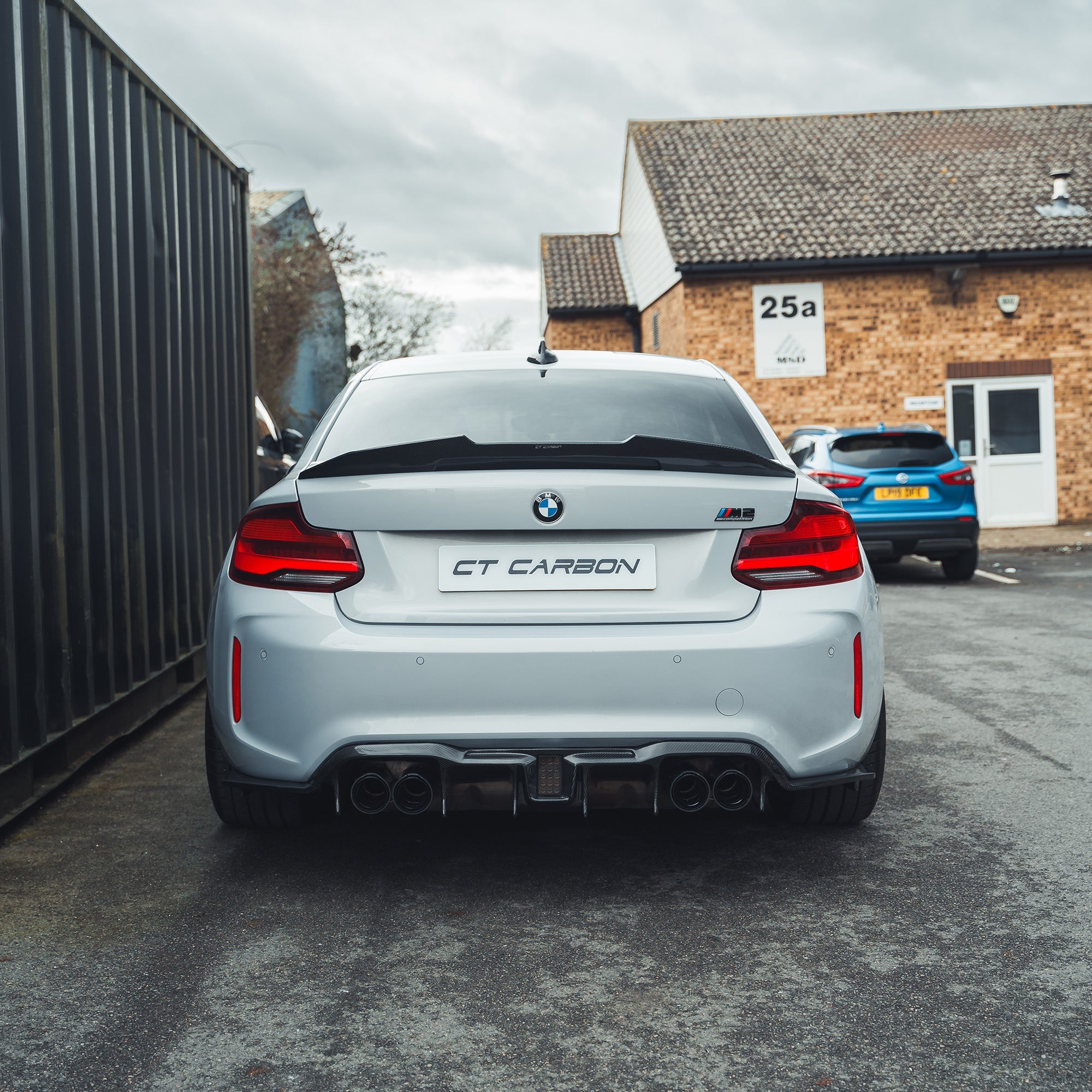 BMW M2 M2C F87 carbon fiber diffuser by CT Carbon, showcasing the aggressive V6 design with detailed carbon fiber finish.