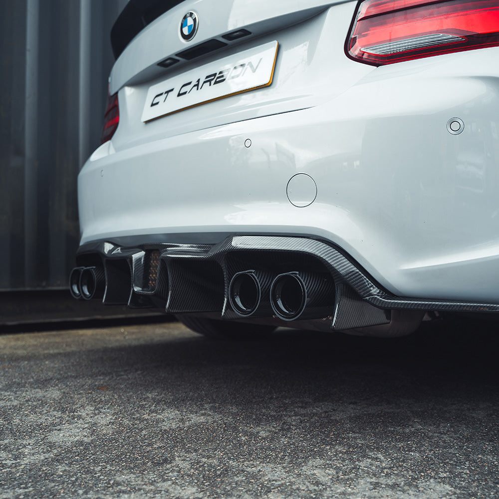 BMW M2 F87 carbon fibre diffuser by CT Carbon, showcasing an aggressive V6 design with sleek, textured carbon fiber finish.