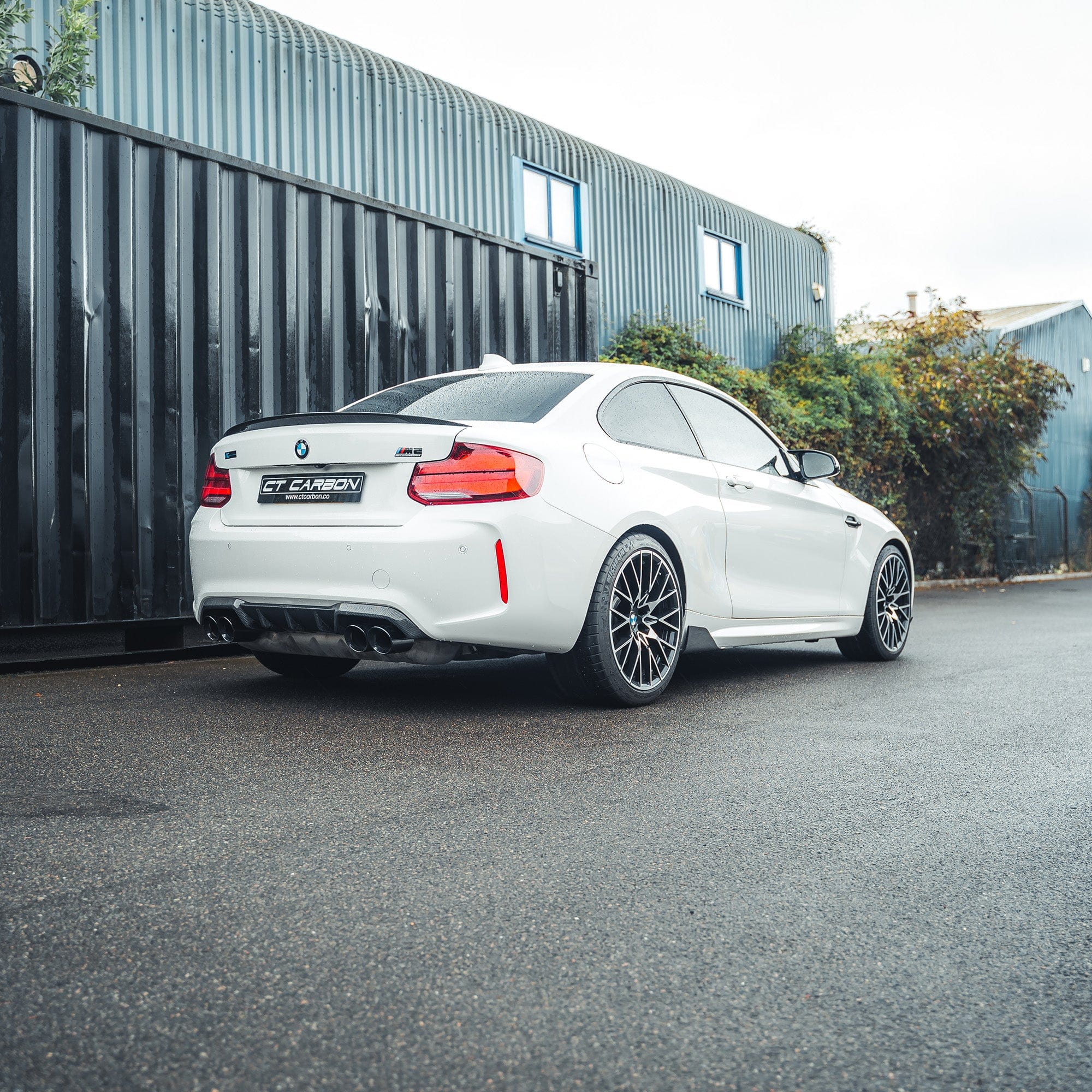 BMW M2 F87 carbon fibre diffuser by CT Carbon, V2 style, showcasing sleek, lightweight aerodynamic design on the car.