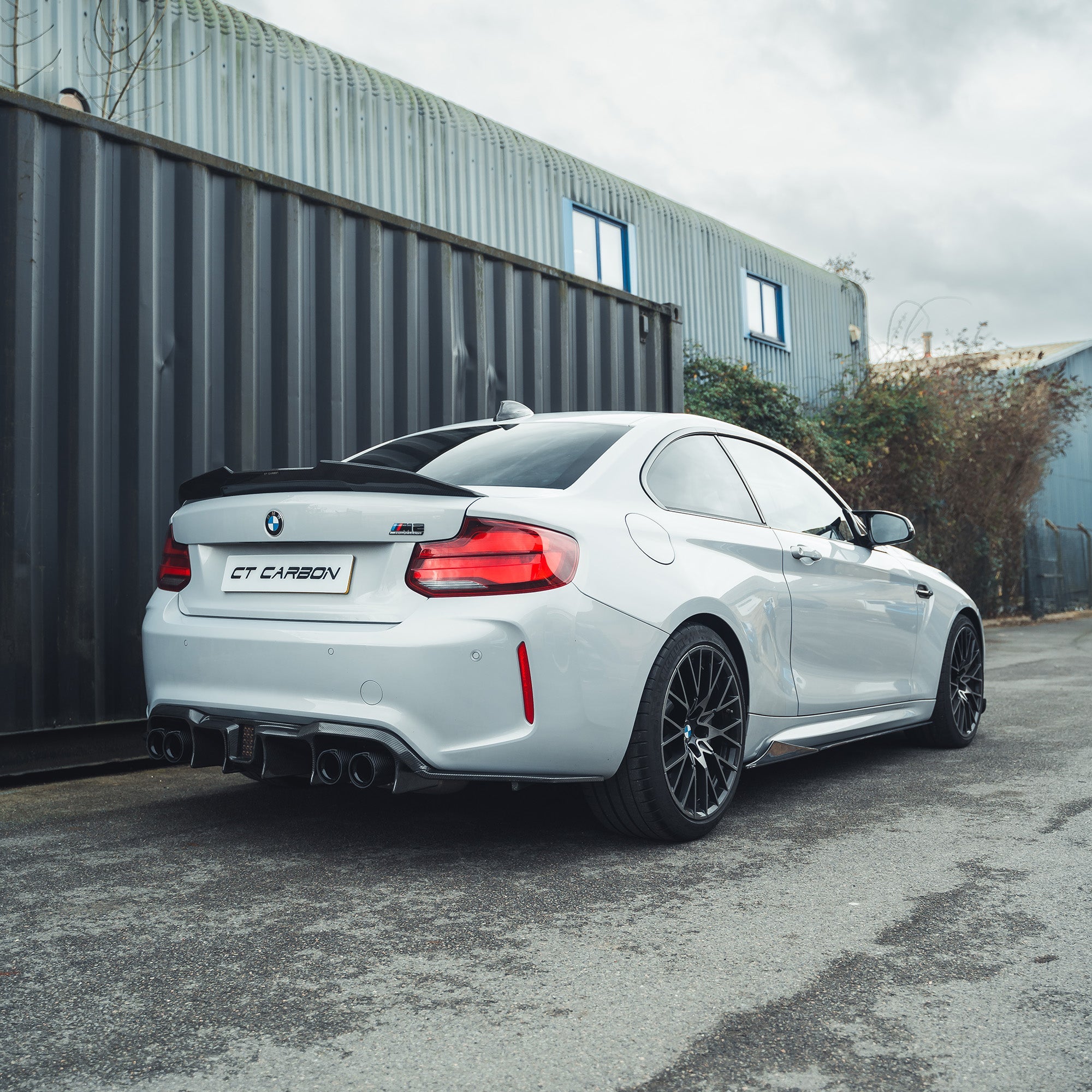 BMW M2 F87 carbon fibre side skirts by CT Carbon, V2 style, showcasing sleek, lightweight aerodynamic design on the car.