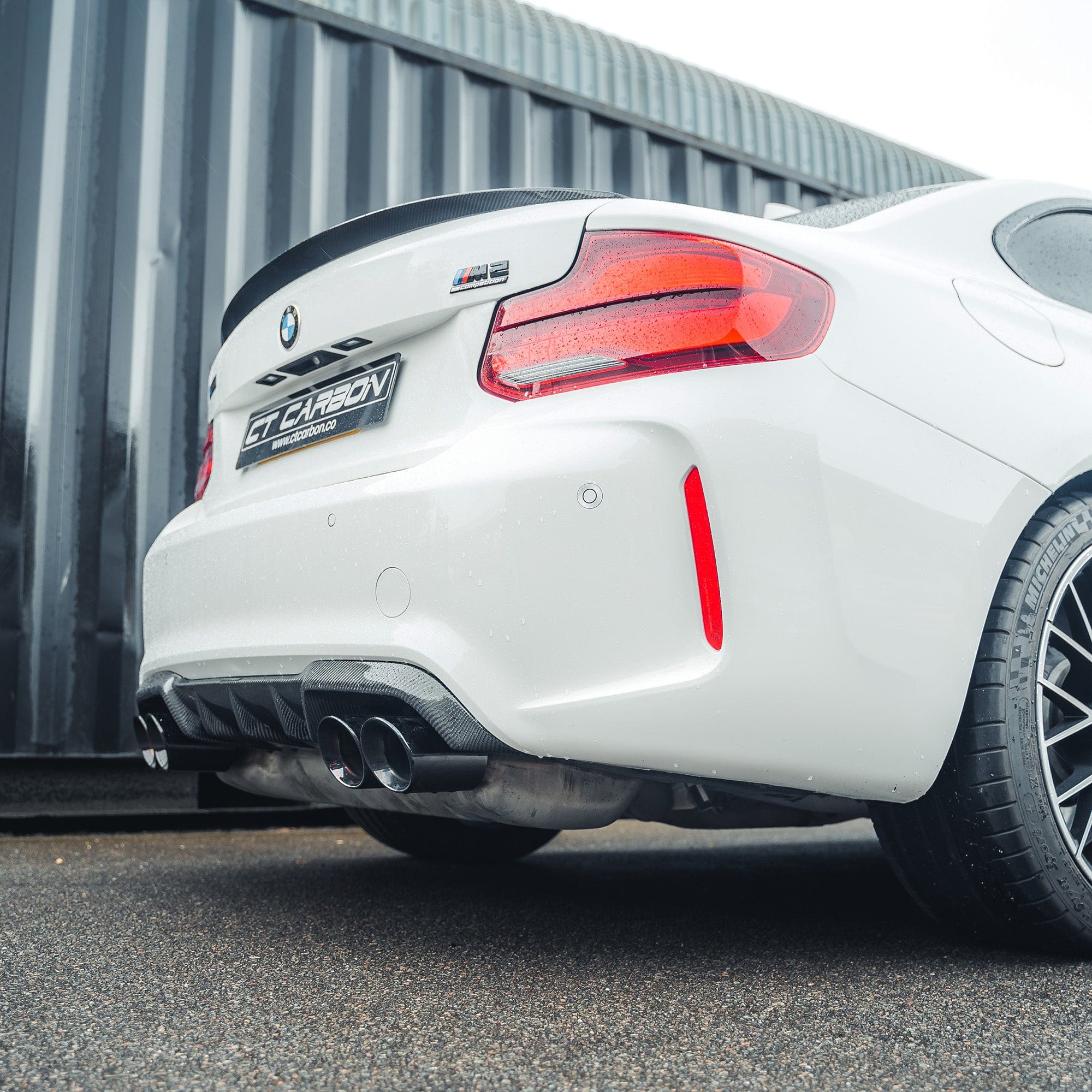 BMW M2 M2C F87 F22 carbon fiber spoiler by CT Carbon, showcasing the sleek, aerodynamic design on the car's rear.