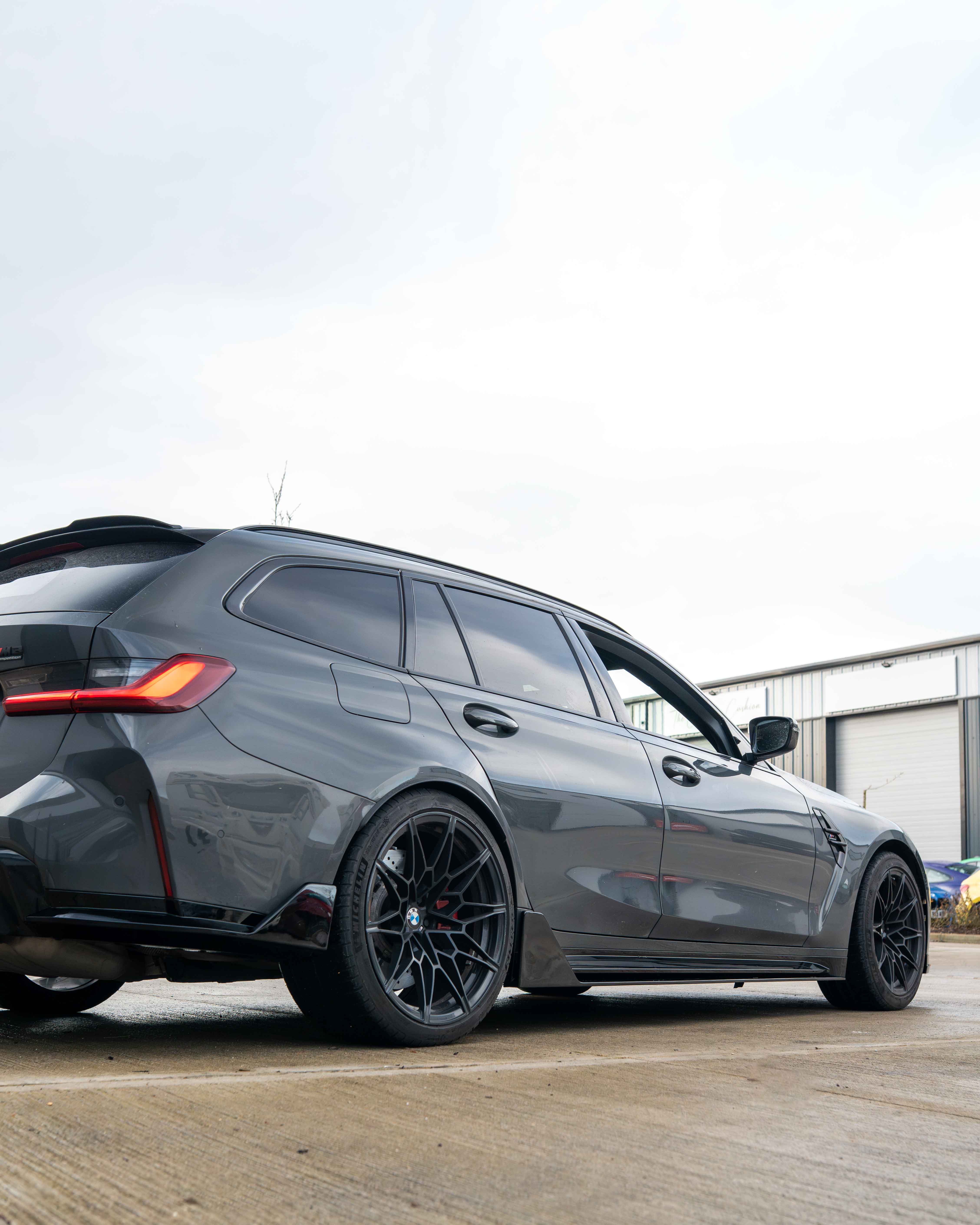 BMW M3 G80 G81 side skirts in gloss black by CT Carbon, featuring sleek MP style design on a sporty vehicle.