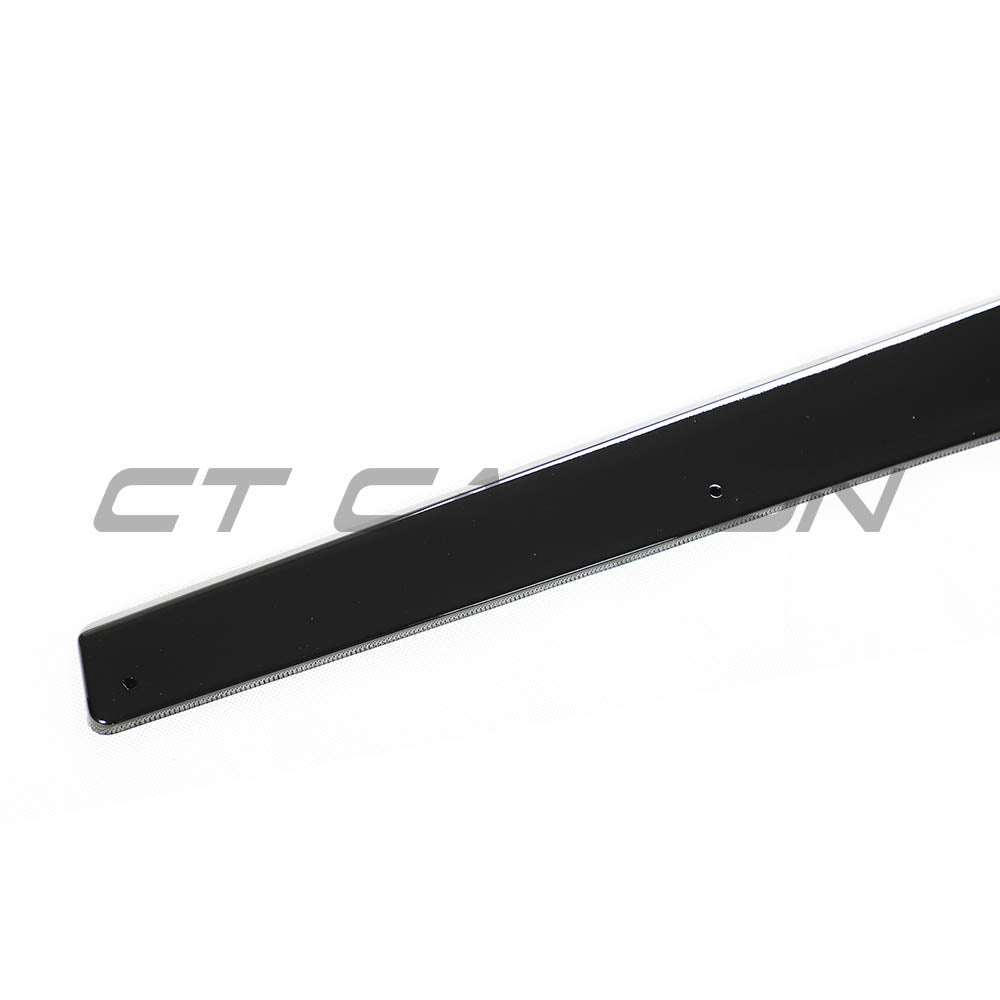 BMW M3 M4 F80 F82 F83 CT Carbon gloss black side skirts installed on the vehicle, showcasing sleek automotive styling.