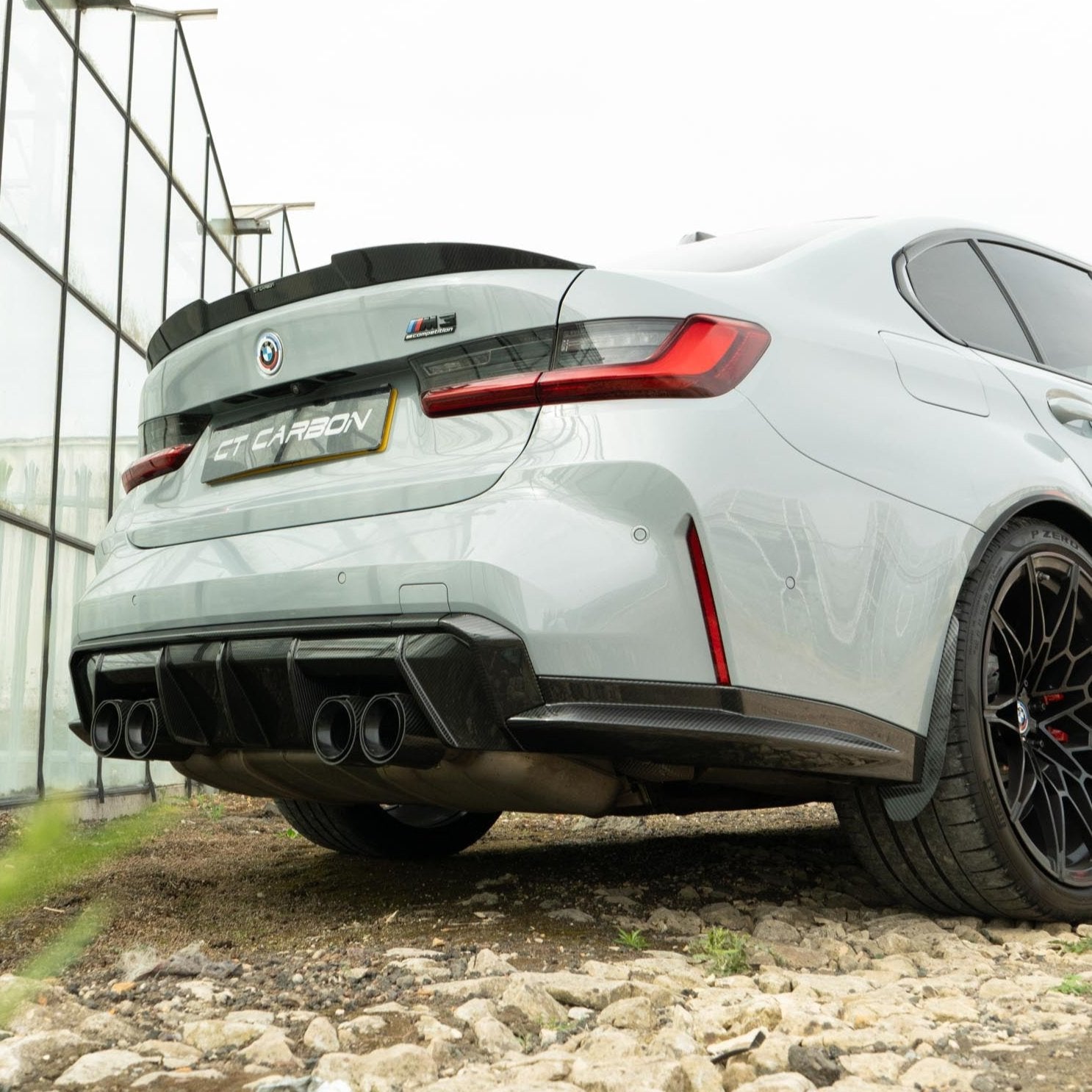 BMW M3 M4 G80 G82 G83 carbon fiber diffuser by CT Carbon, showing the sleek V2 design with textured carbon fiber finish.