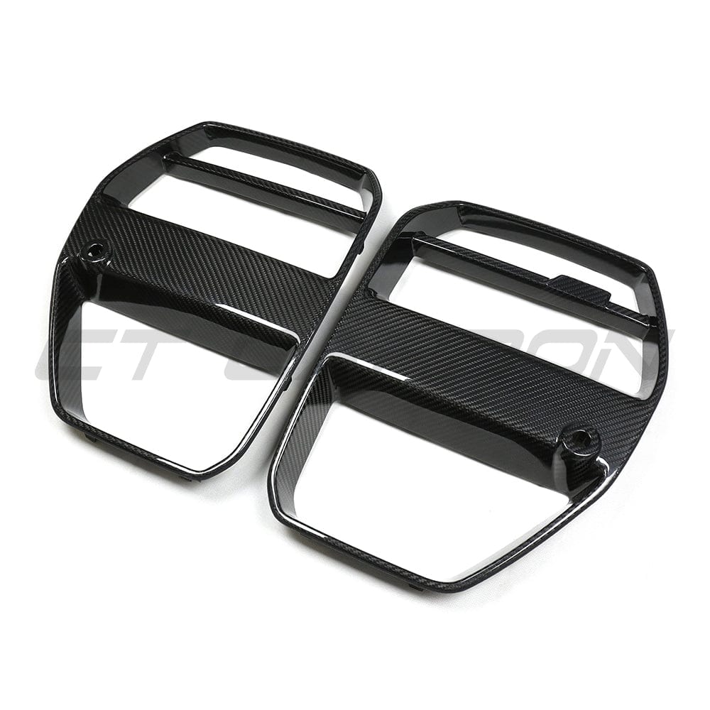 BMW M3 M4 G80 G81 G82 G83 Carbon Fibre Grille by CT Carbon, GT style front grille with ACC V1 installed, on a sports car.