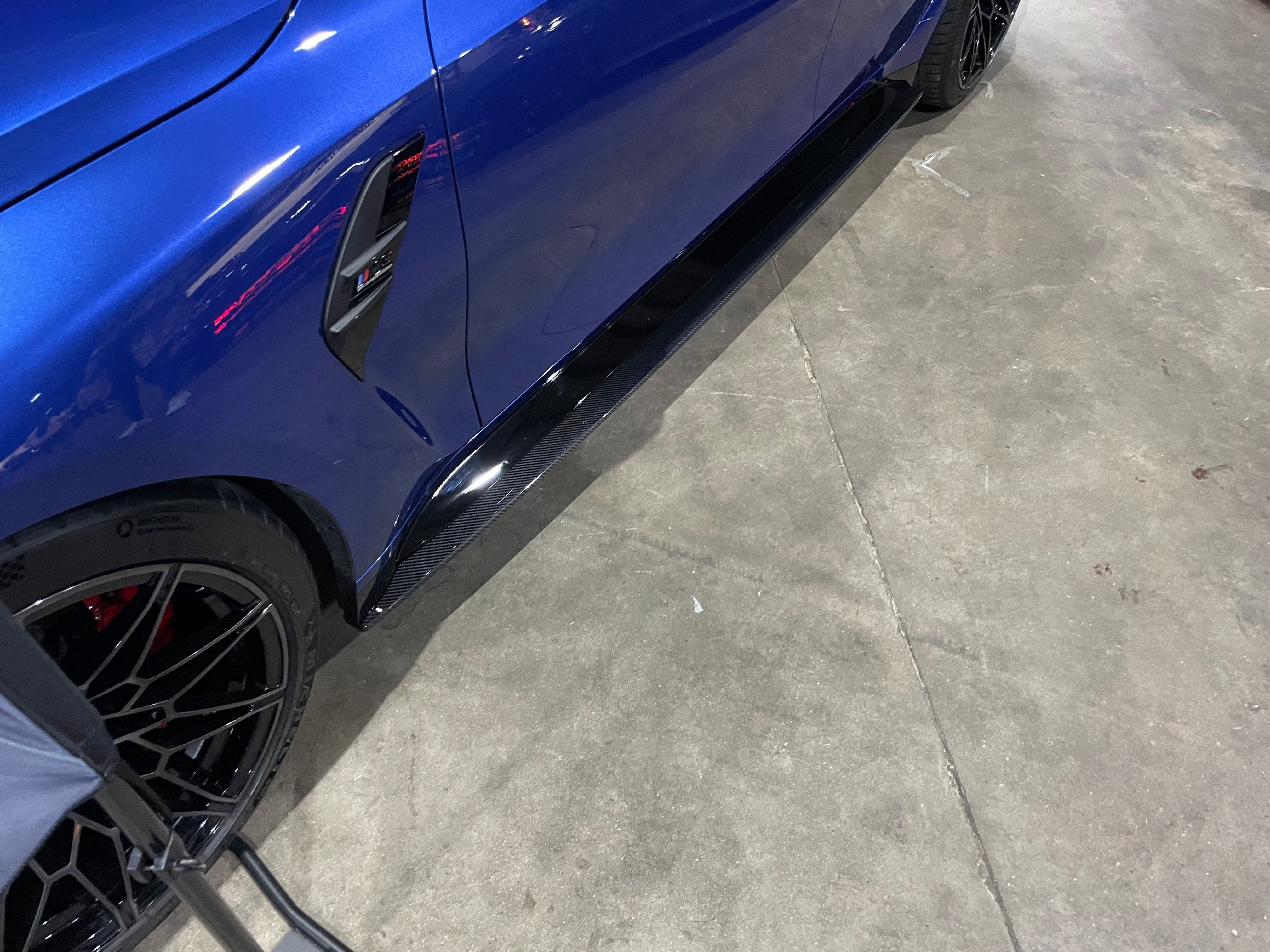 BMW M4 G82 G83 carbon fibre side skirt extensions by CT Carbon, showcasing sleek, aerodynamic design on the vehicle's side.