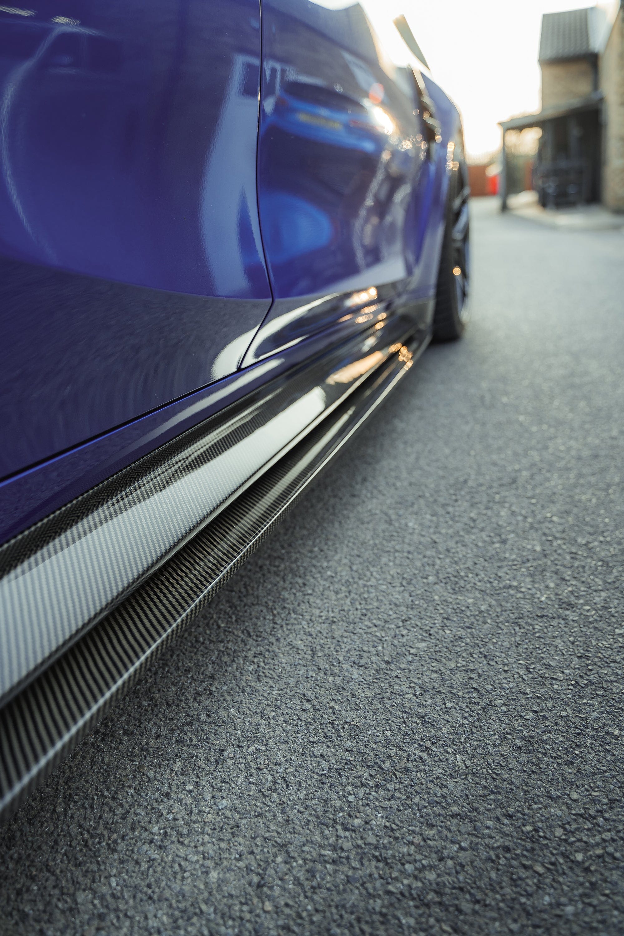 BMW M4 G82 G83 carbon fibre side skirt replacement and extension by CT Design, showing the sleek, aerodynamic design on the car.