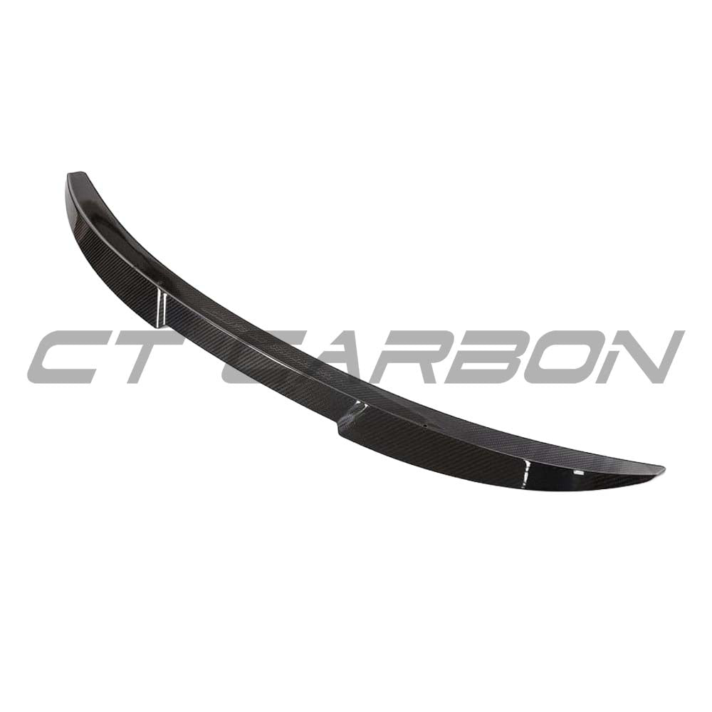BMW G82 M4 full carbon fiber kit by CT Design, featuring a carbon fiber spoiler and body parts on a sports car.