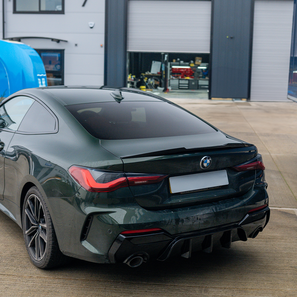 BMW M4 G82 G22 carbon fiber spoiler by CT Carbon, showcasing sleek M4-style aerodynamic design on a sports car.