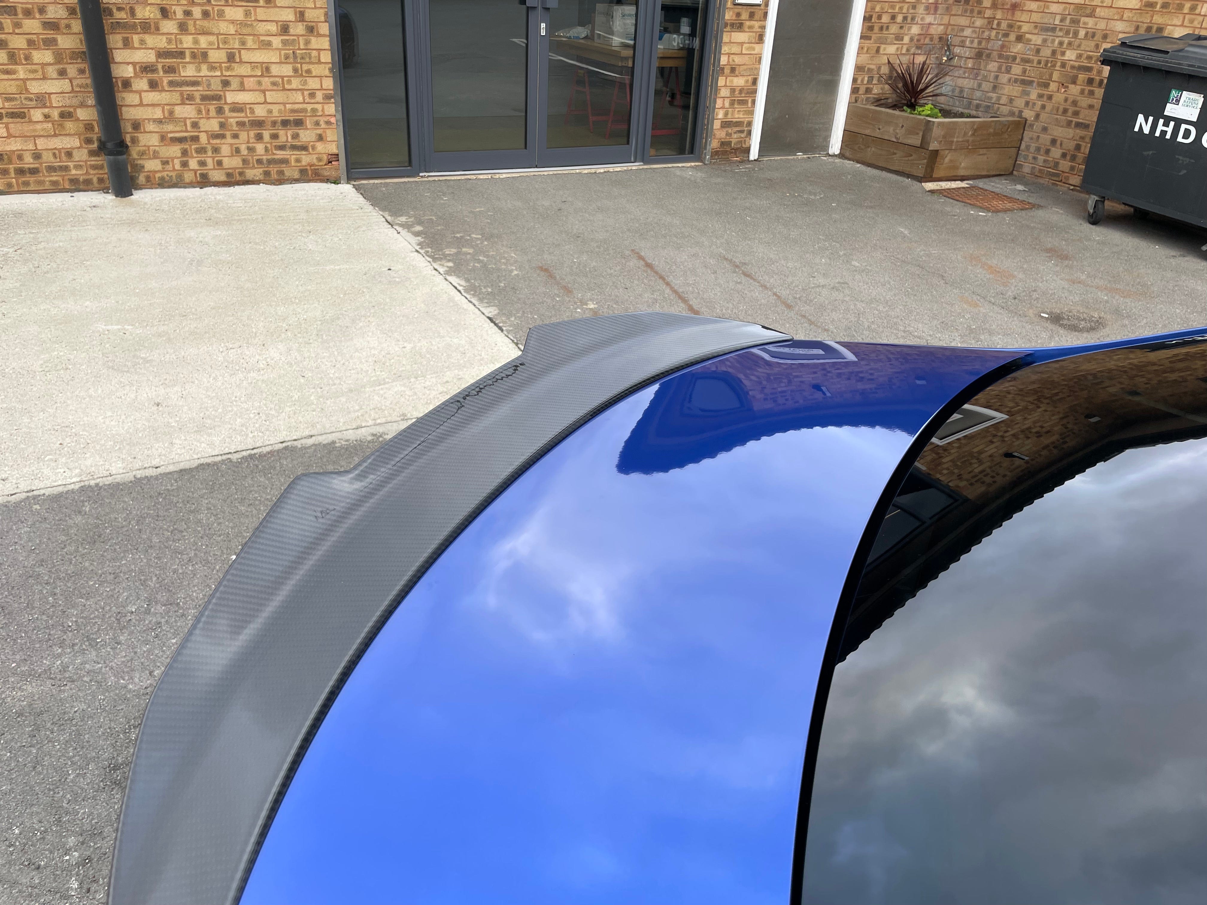 BMW M4 G82 G22 carbon fibre spoiler by CT Carbon, V1, showcasing sleek aerodynamic design on the car's rear.