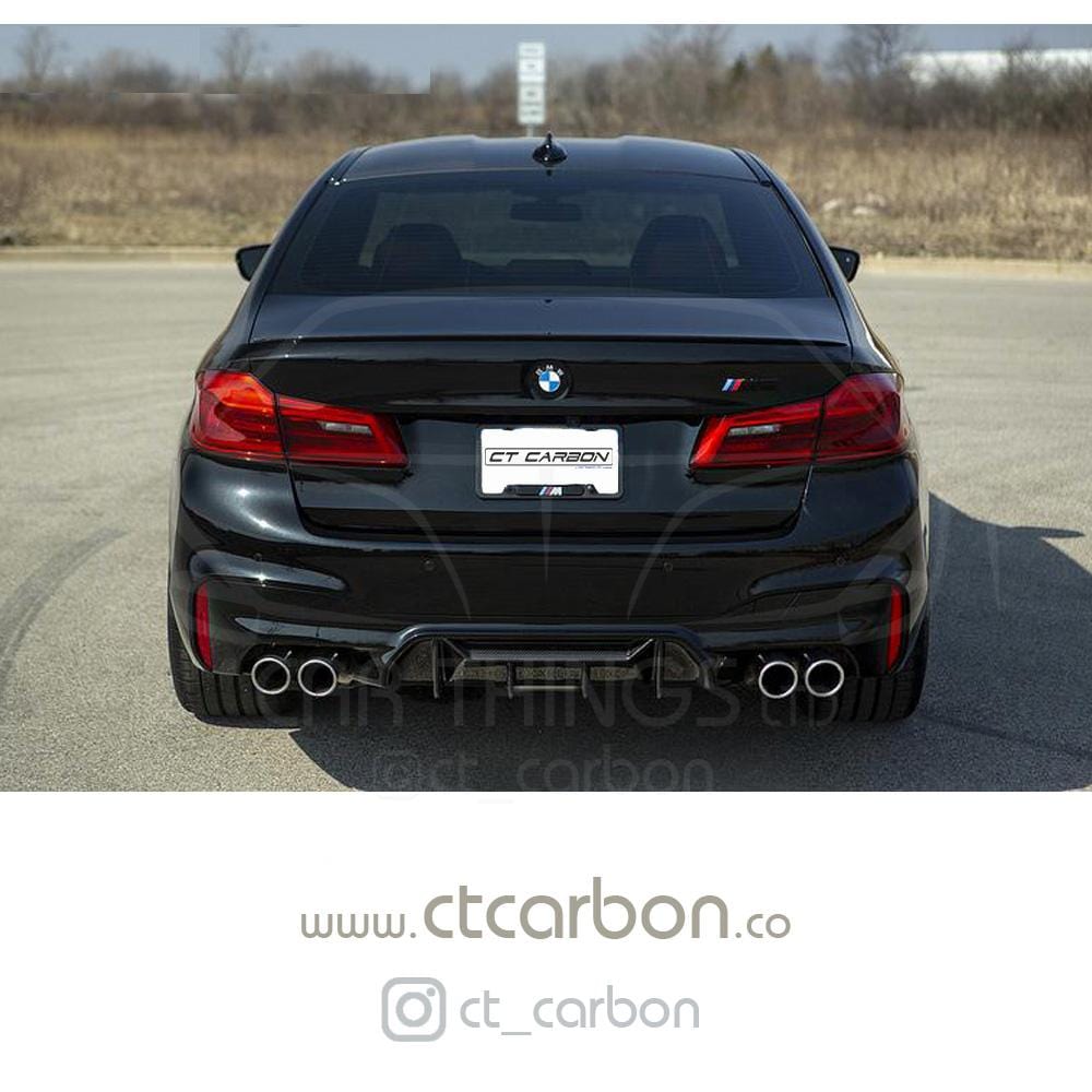 BMW M5 F90 carbon fibre diffuser by CT Carbon, V1 style, showing the sleek black carbon fiber finish and aerodynamic design.