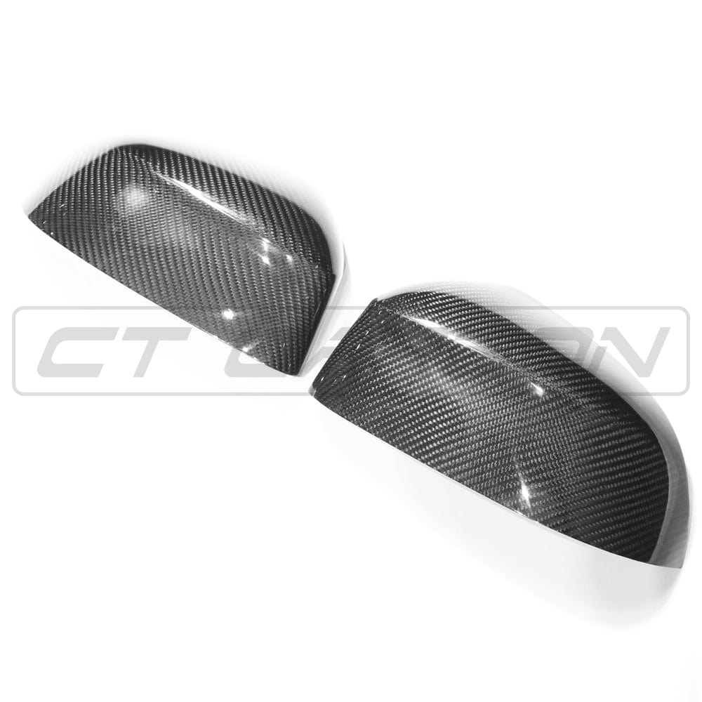 BMW X3, X4, X5, X6 carbon fiber mirrors by CT Carbon, OEM style, close-up of sleek carbon fiber mirror covers on vehicle.