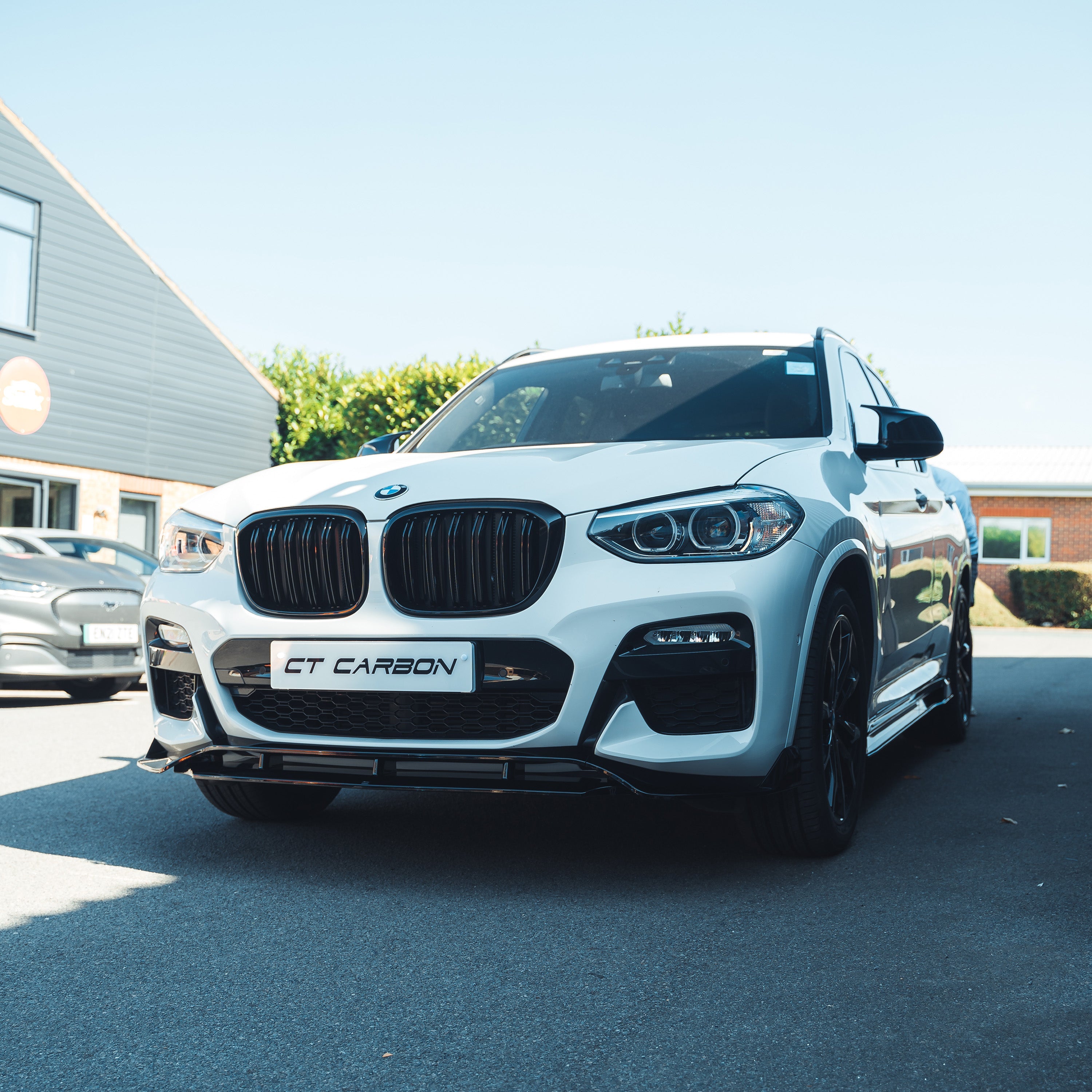 Black double slat grille for BMW G01 X3 2017-2021 by CT Carbon, shown on a glossy black vehicle.