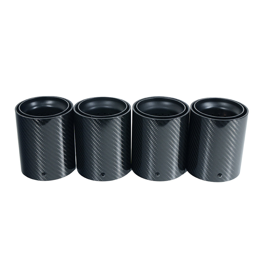 Pair of matte black carbon fiber exhaust tips for BMW F90/F92 M5 by CT Carbon, shown from the side view.