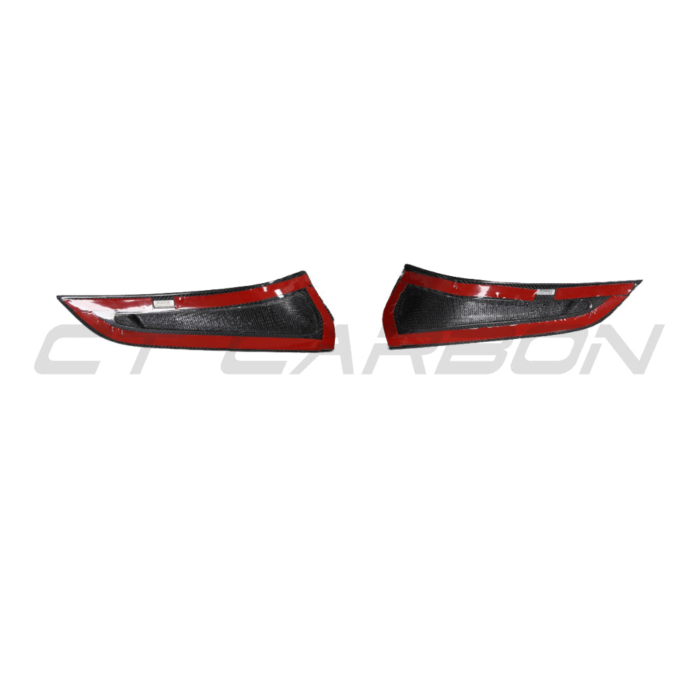 Carbon fiber front bumper vent trim for Toyota Supra 2019+ A90 by CT Carbon, showing detailed textured finish on vehicle's front bumper.