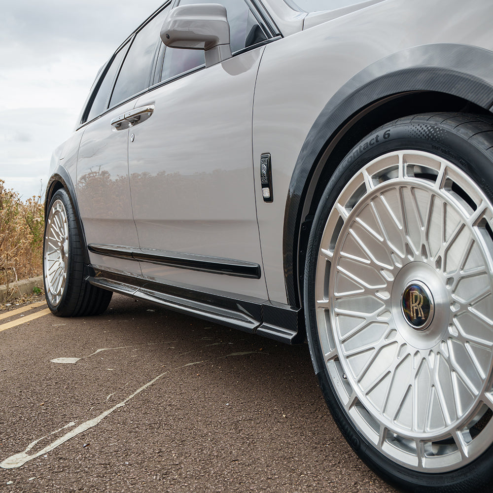 Carbon fiber side skirts for Rolls Royce Cullinan by CT Carbon, showcasing sleek, lightweight splitter design on the luxury SUV.