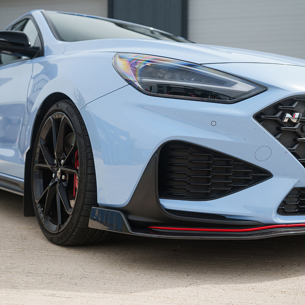 Hyundai i30N front carbon fiber splitter by CT Design, showcasing its sleek, aerodynamic design on the car's front bumper.