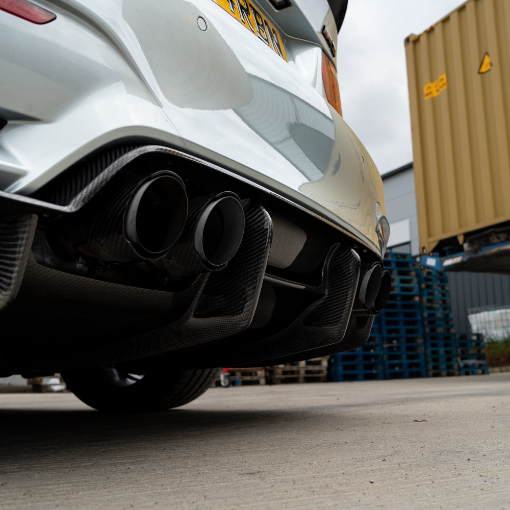 BMW M3 M4 F80 F82 F83 CT Carbon fiber diffuser V4, sleek black automotive diffuser with textured carbon fiber finish.