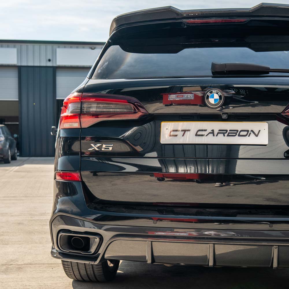 BMW G05 X5 full carbon fiber kit by CT Carbon, showing black textured carbon fiber panels and parts for the vehicle.