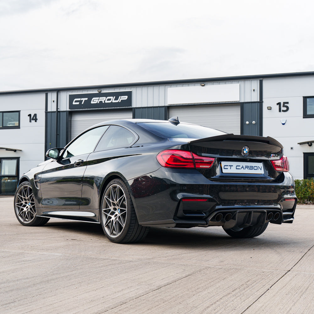 BMW M4 F82 carbon fibre V Style spoiler by CT Carbon, showcasing sleek aerodynamic design on a sporty vehicle.