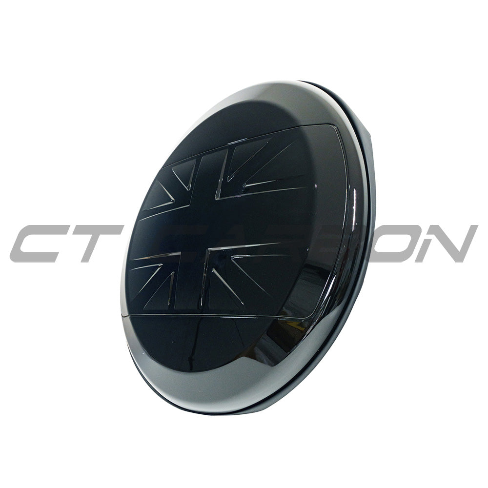 Gloss black spare wheel cover for Land Rover Defender L663 110 and 90 by CT Carbon, showing a sleek, fitted accessory on a vehicle wheel.