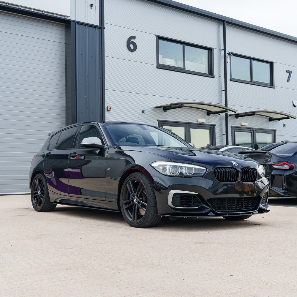BMW F20/F21 1 Series LCI V2 gloss black splitter by CT Carbon, showing close-up of the sleek aerodynamic car splitter.