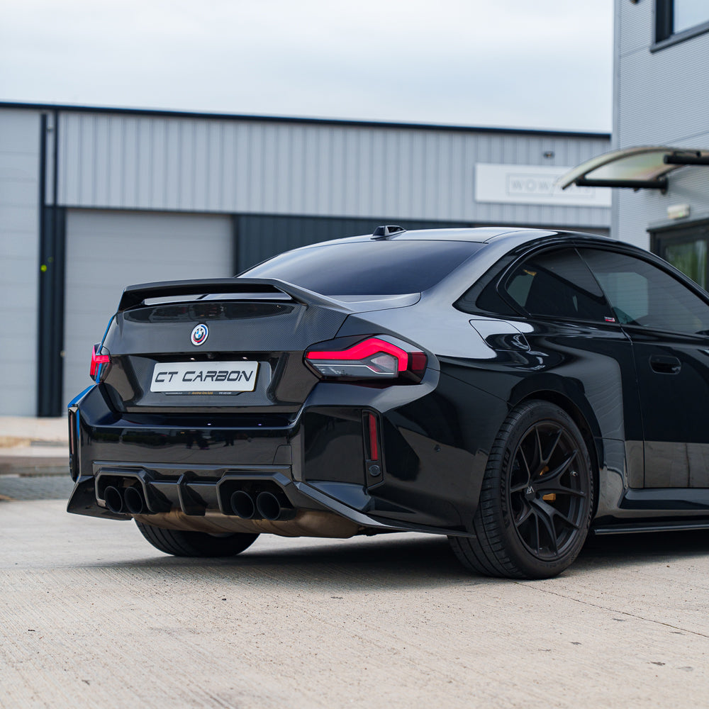 BMW G87 M2 CT Carbon full car conversion kit with carbon fiber components, displayed on a dark background.