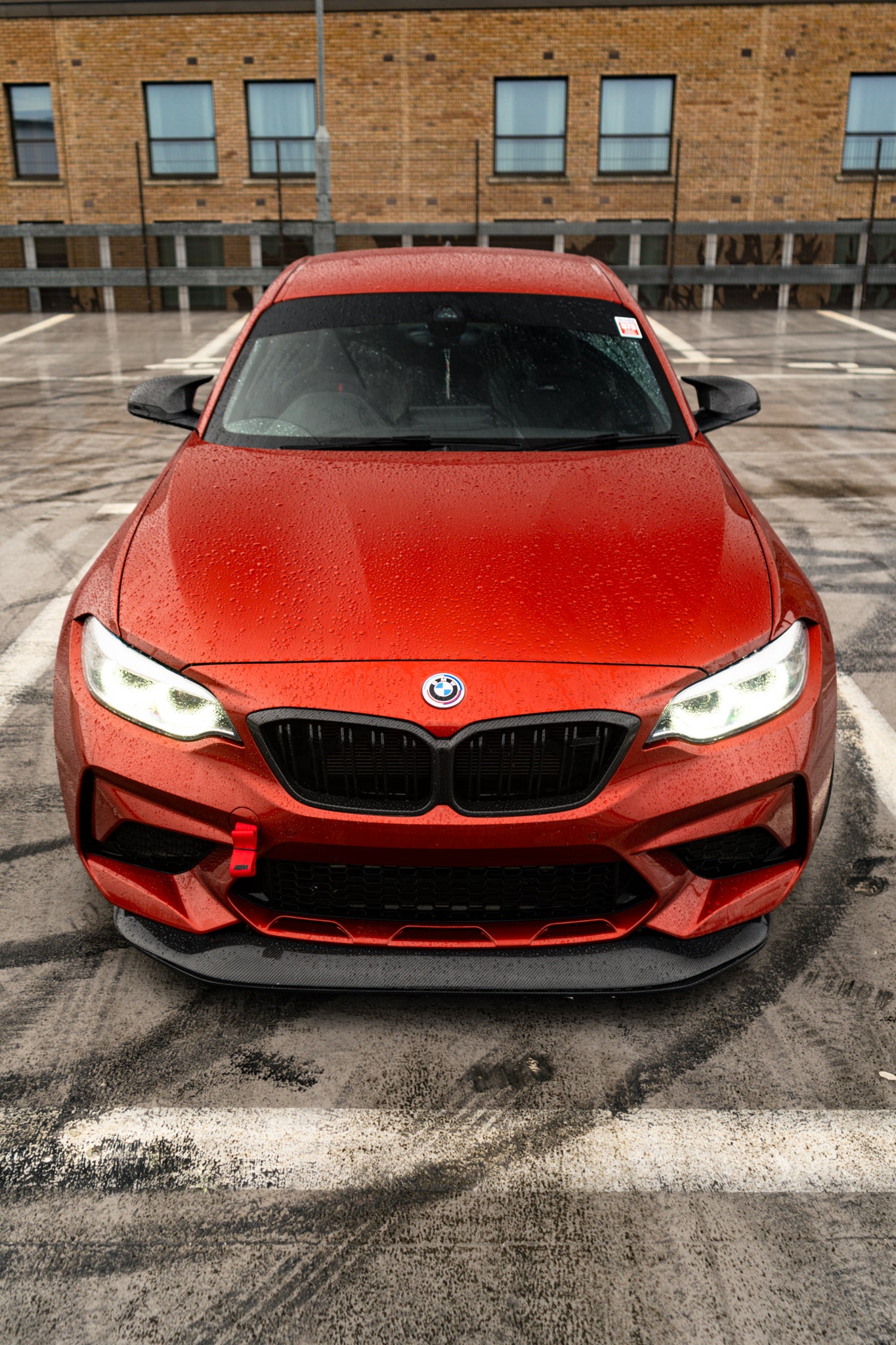 Ridgeline Motorsport F87 M2 Competition carbon fibre GTS front splitter mounted on a BMW M2, showcasing aerodynamic design and finish.