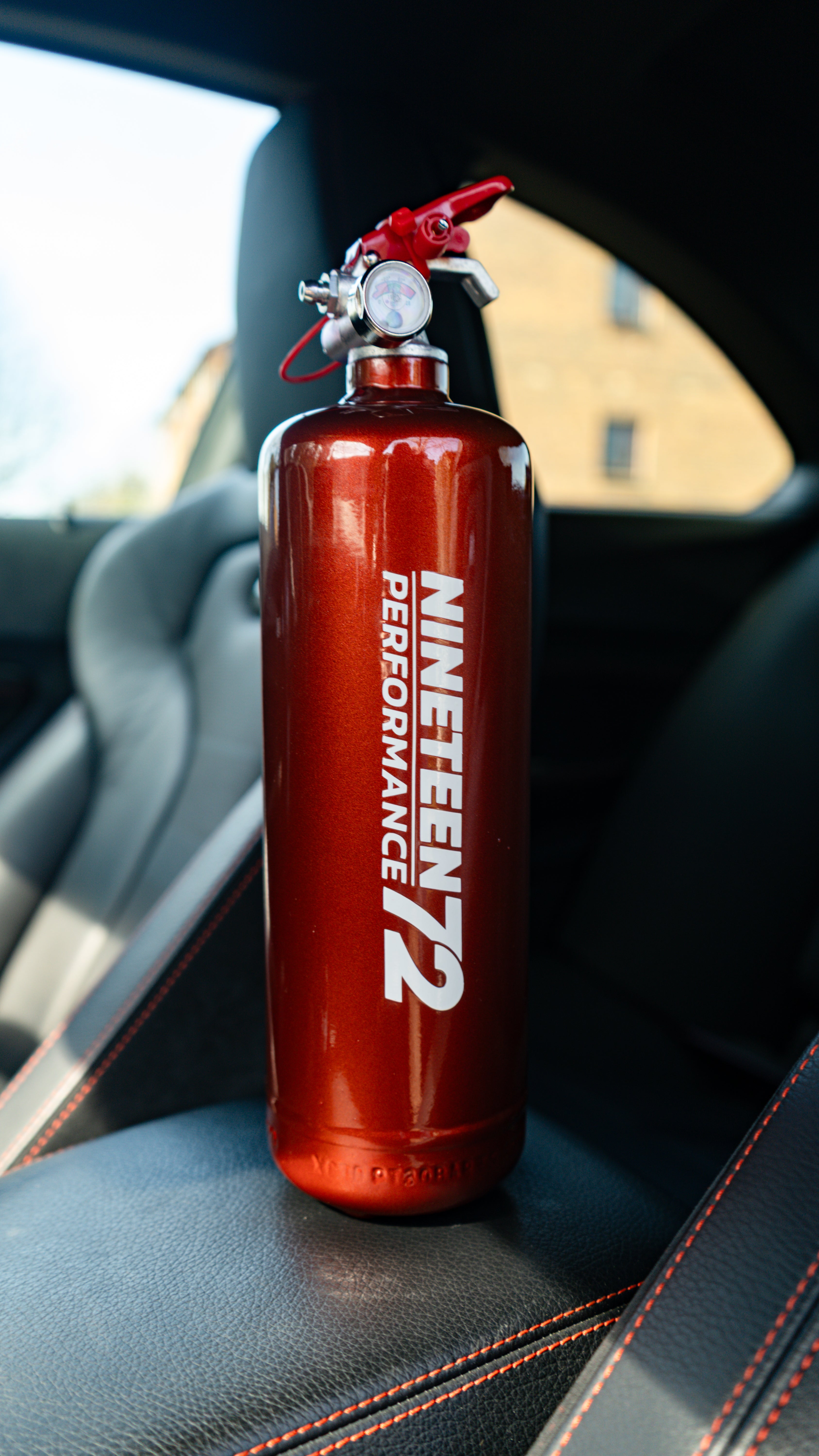 BMW F8X fire extinguisher kit from Race Safe, featuring compact fire extinguishers designed for footwell installation.