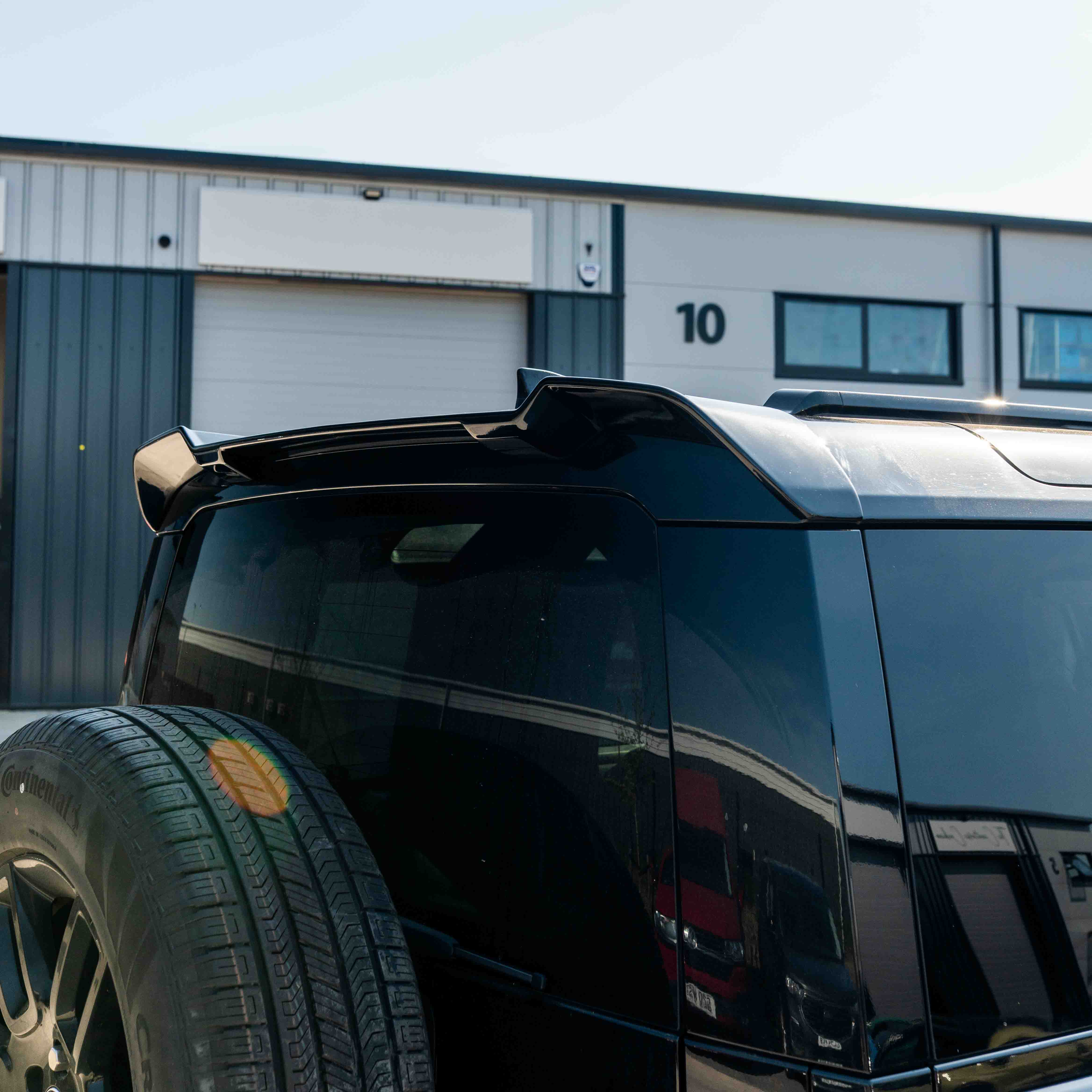 CT Carbon Land Rover Defender L663 110 & 90 gloss black front and rear middle trim kit, durable automotive interior upgrade.