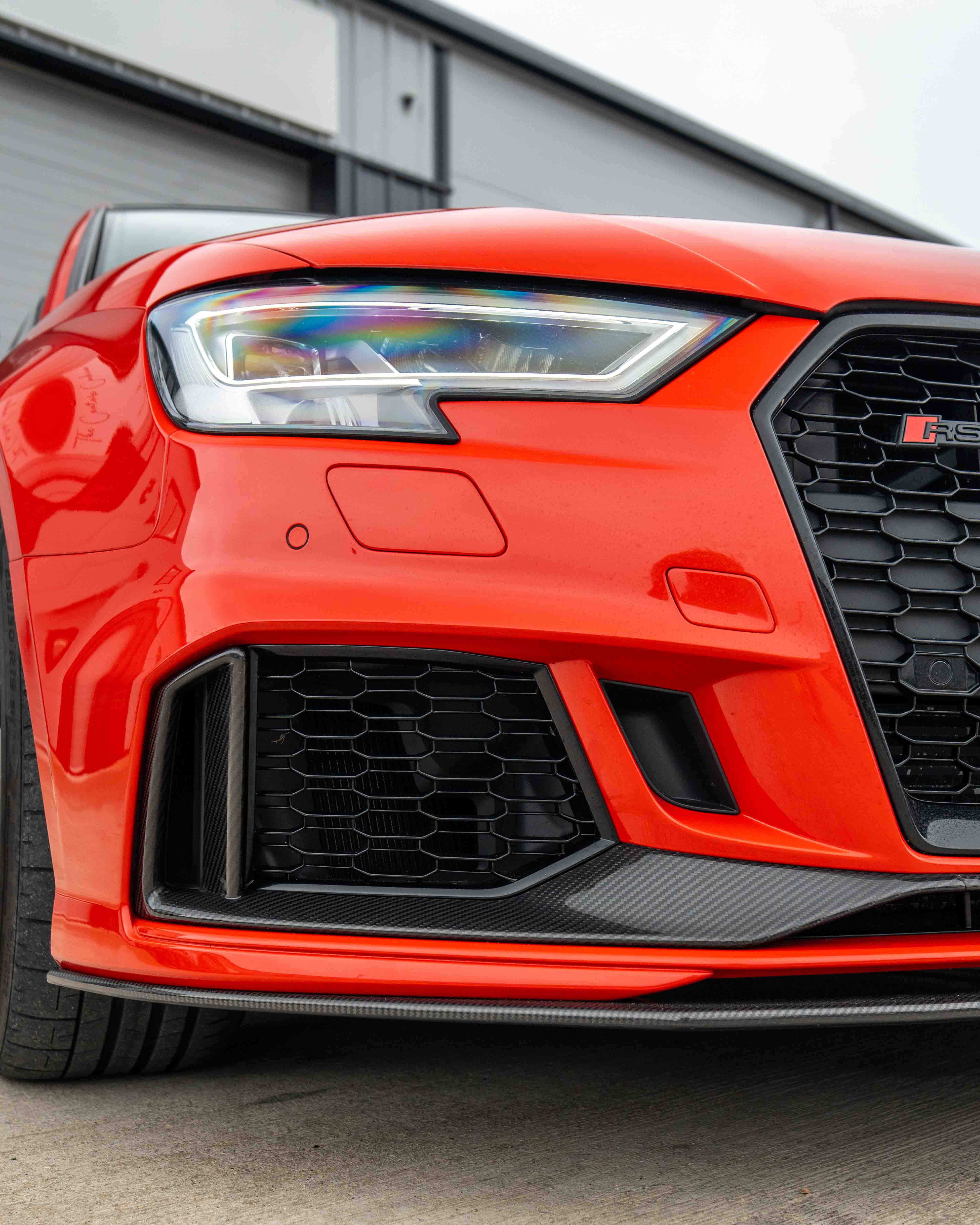 CT Carbon Audi RS3 8V saloon carbon fibre splitter V1, sleek black aerodynamic car accessory on a white background.