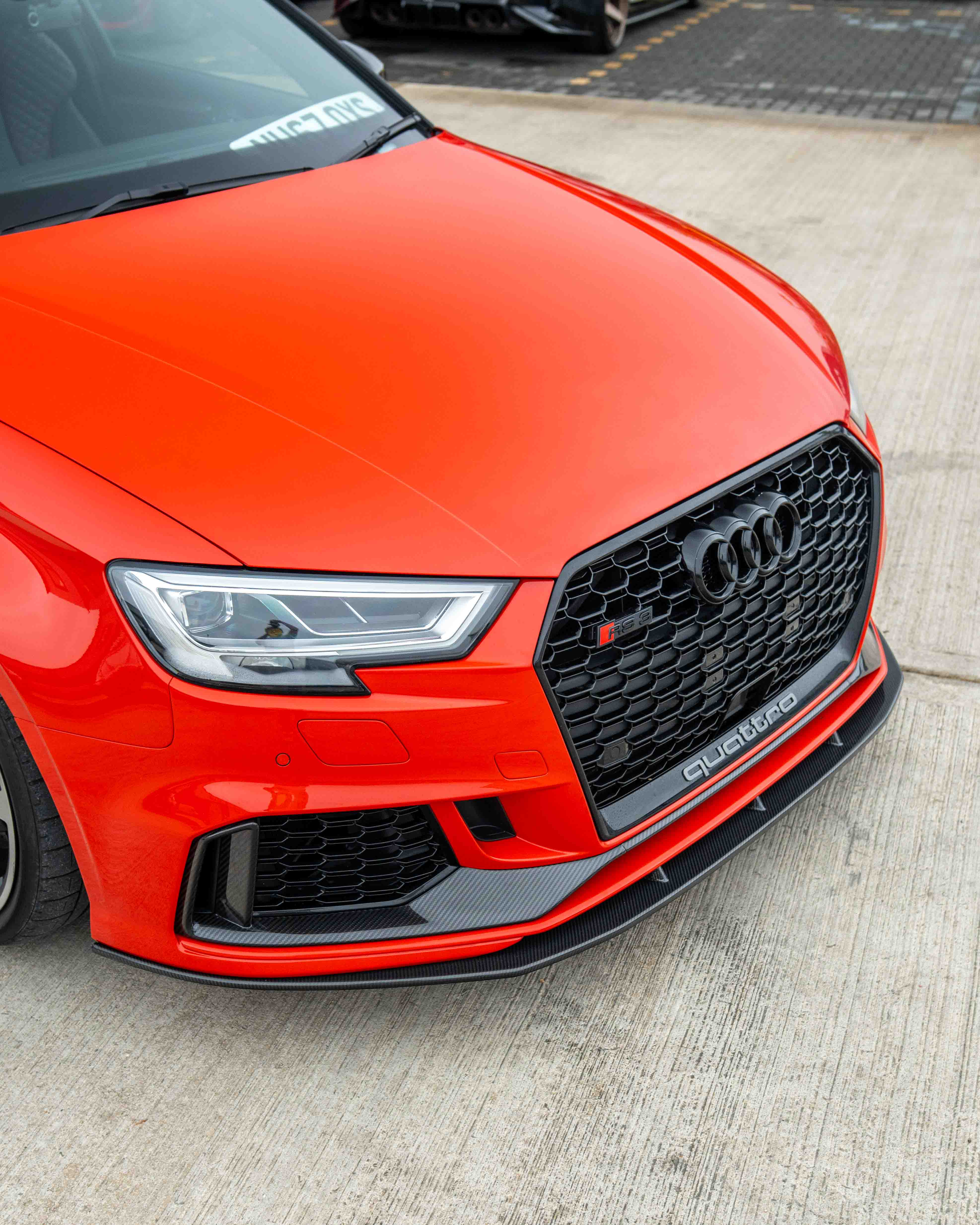 Audi RS3 8V facelift carbon fiber bumper trim accessory by CT Carbon, shown on a sleek car with close-up focus on the trim.