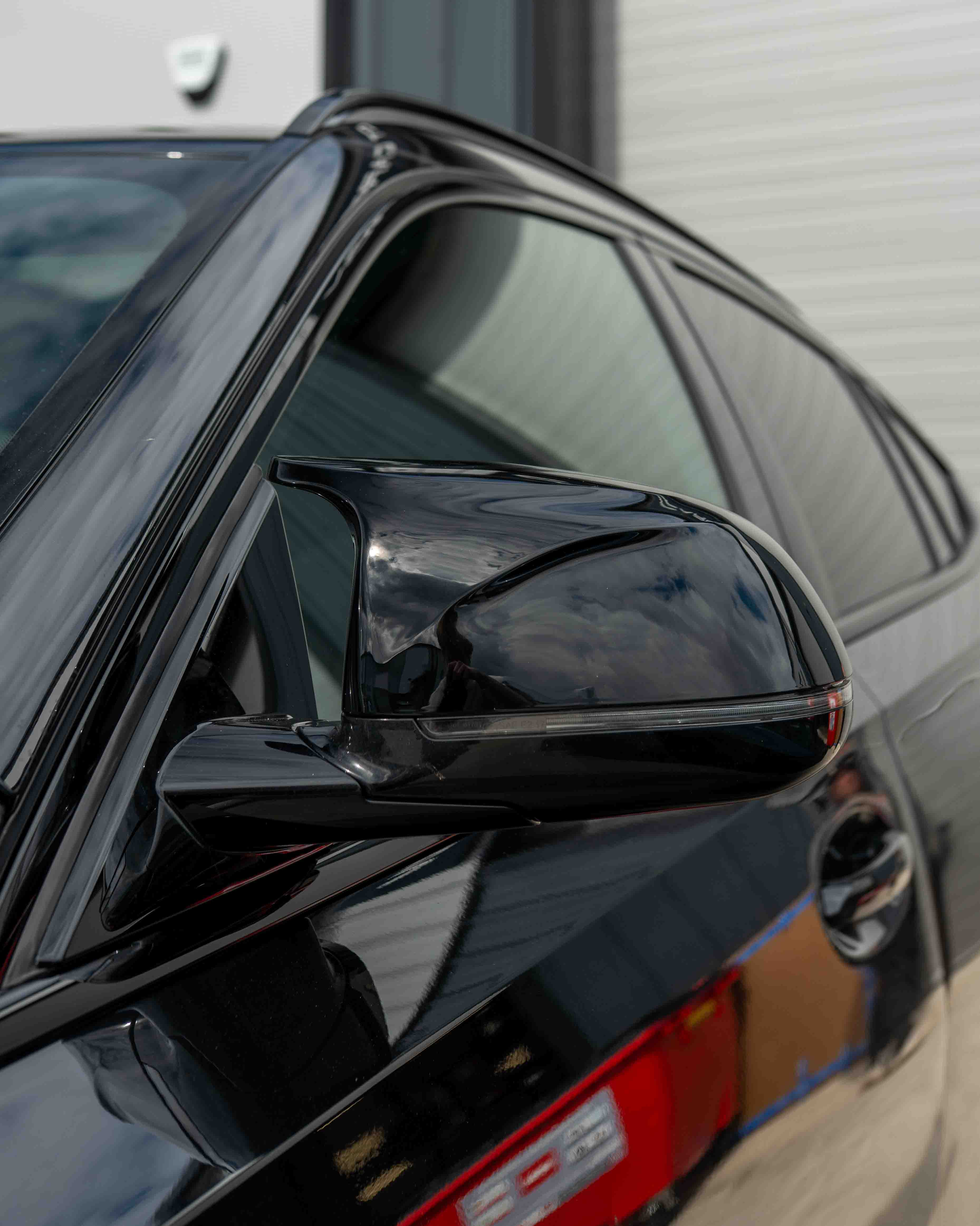 Gloss black carbon fiber side mirrors for BMW X3, X4, X5, X6 G01, G02, G05, G06 by CT Carbon, close-up of mirror housing.