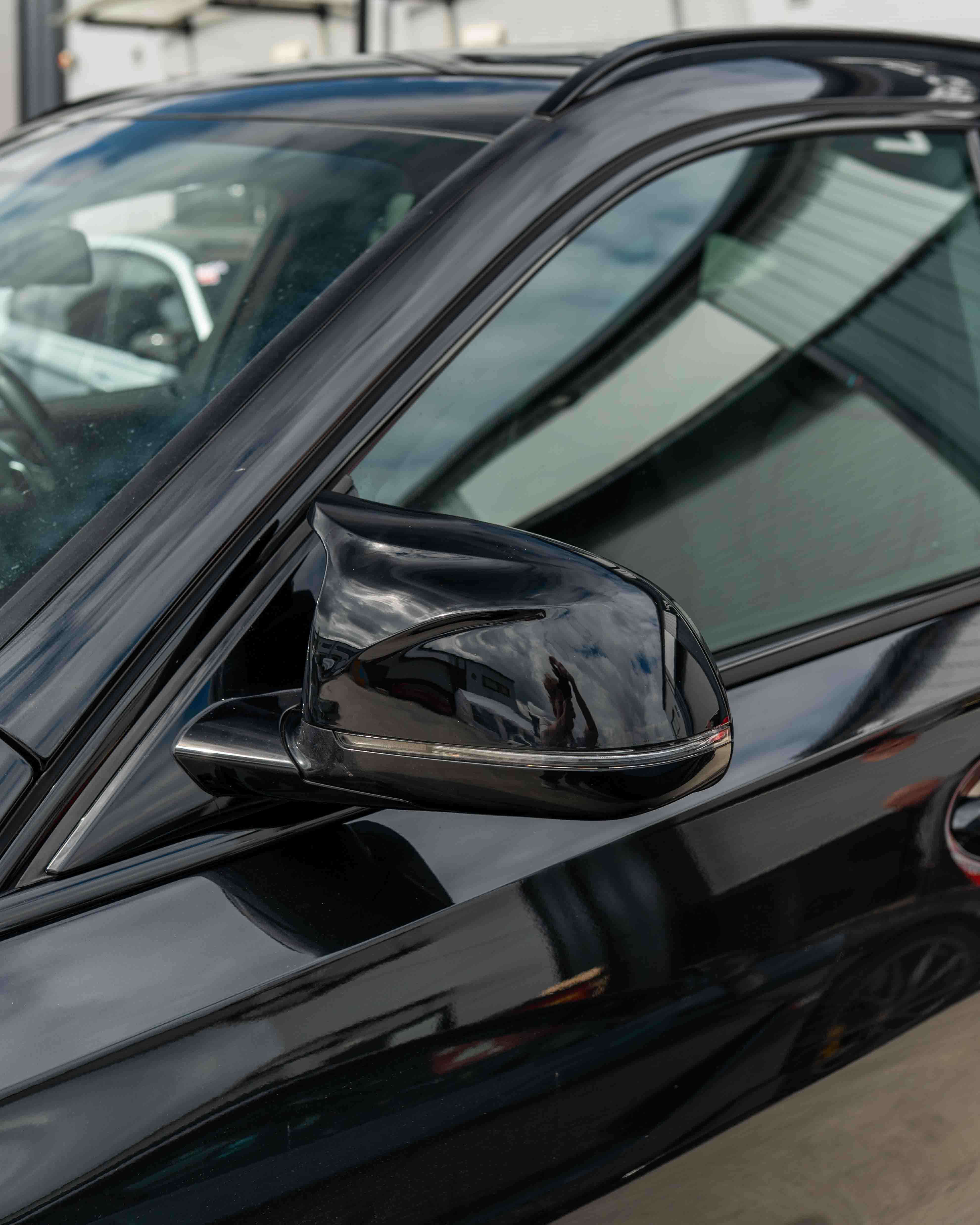 Gloss black BMW X3/X4/X5/X6 G01/G02/G05/G06 mirror accessories by CT Carbon, showing sleek exterior side mirrors.