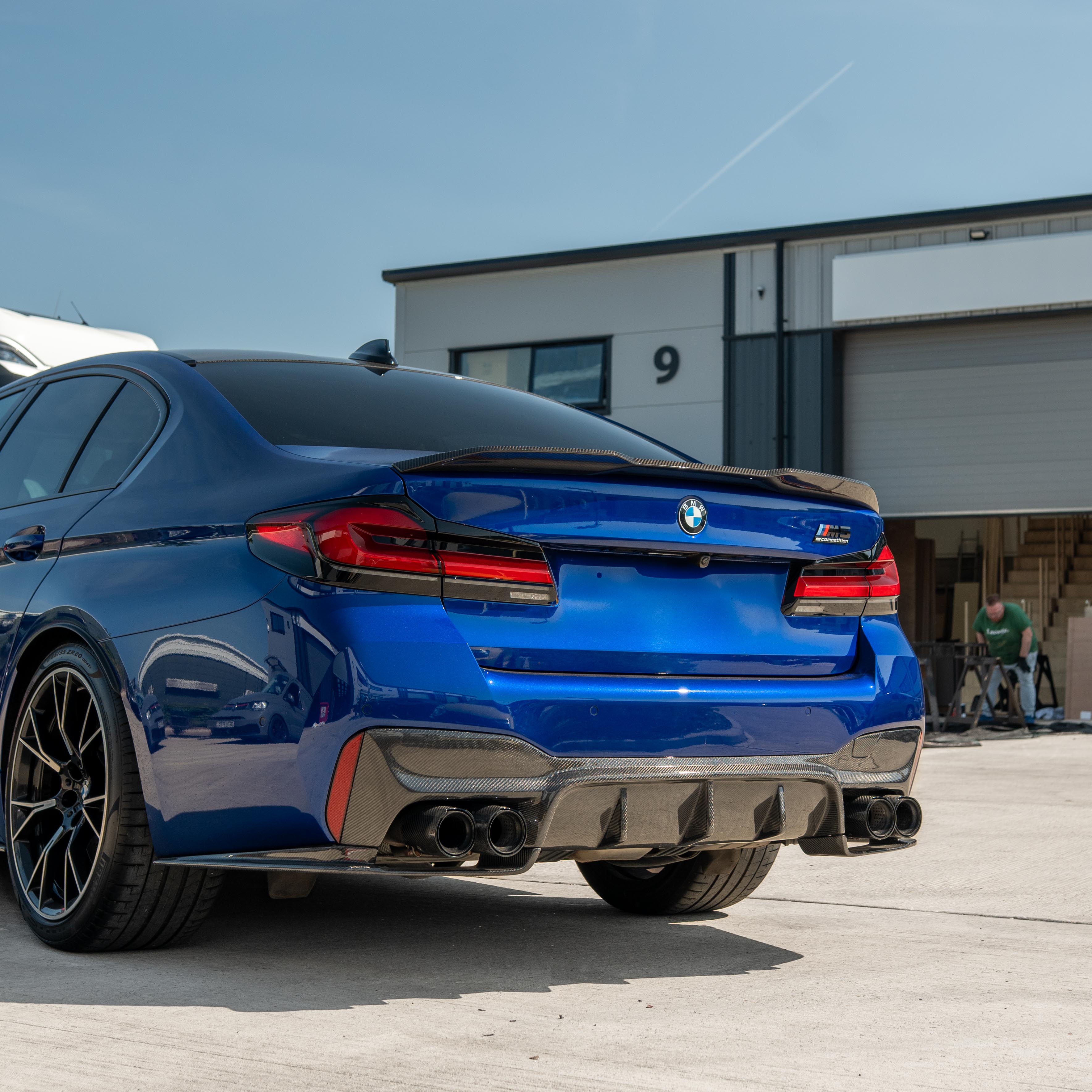 BMW M5 F90 and G30 5 Series carbon fibre spoiler by CT Carbon, shown on a sleek sports car with a matte finish.