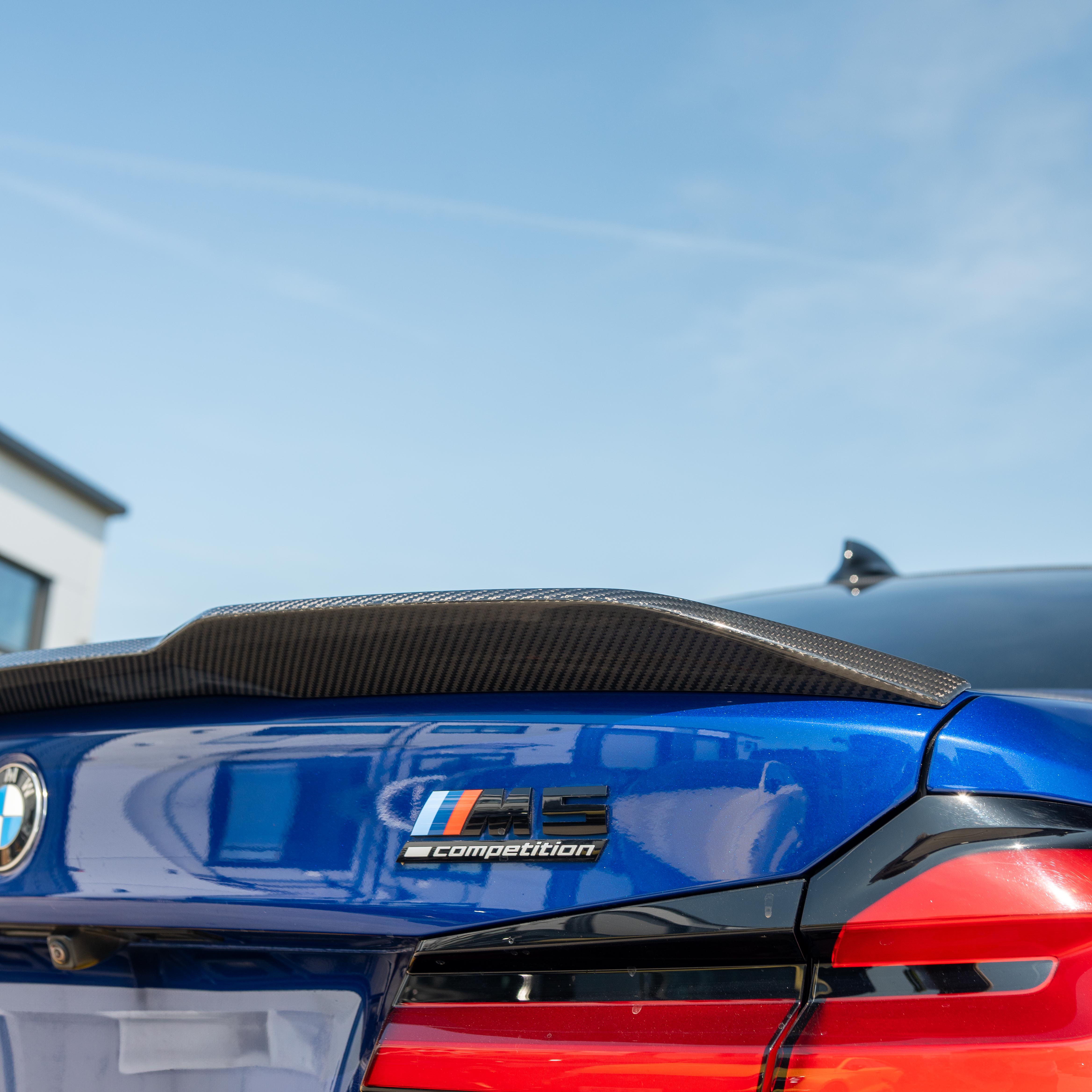BMW M5 F90 and G30 5 Series carbon fibre spoiler by CT Carbon, showing the sleek, aerodynamic design on a silver car.