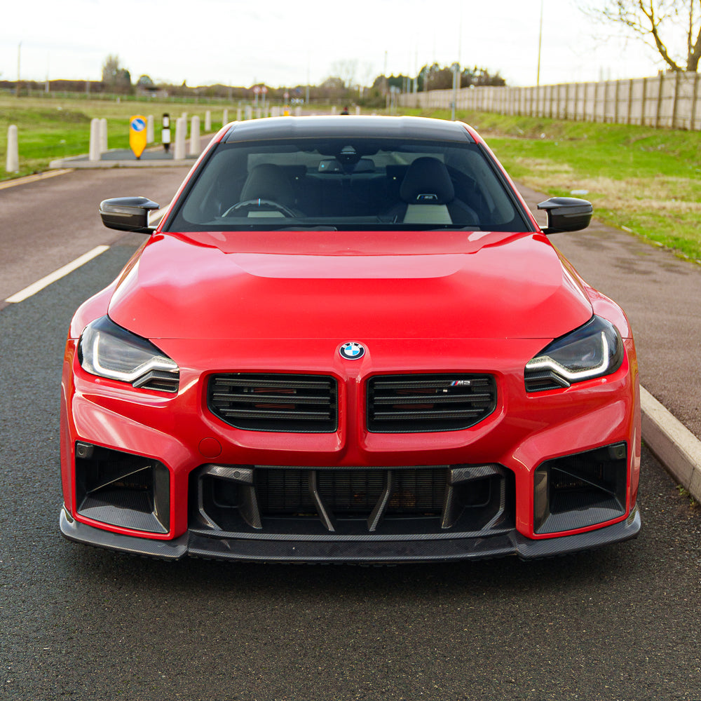 BMW G87 M2 2023 carbon fibre splitter by CT Carbon, V2 model, showing the sleek aerodynamic design and textured carbon finish.