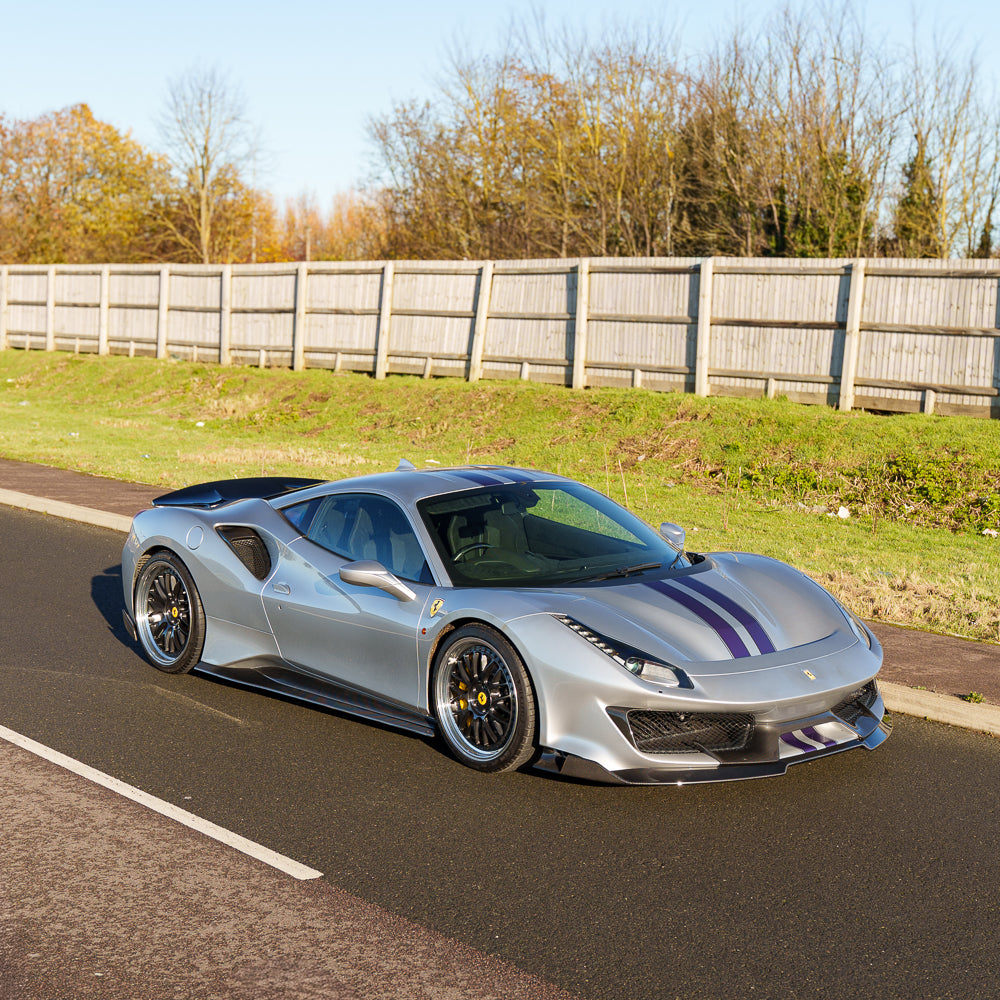 Carbon fibre kit for Ferrari 488 Pista by CT Carbon, featuring detailed carbon fibre components on a sports car.