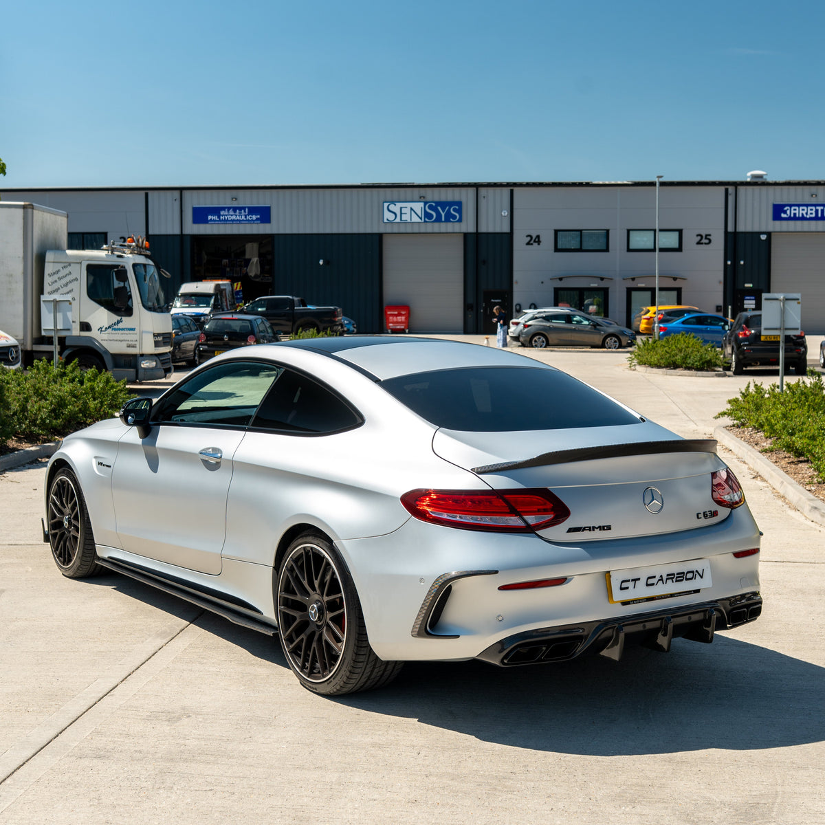 CT Carbon side skirts for Mercedes W205 C63 and C63S coupe and saloon, carbon fiber finish, shown on vehicle.