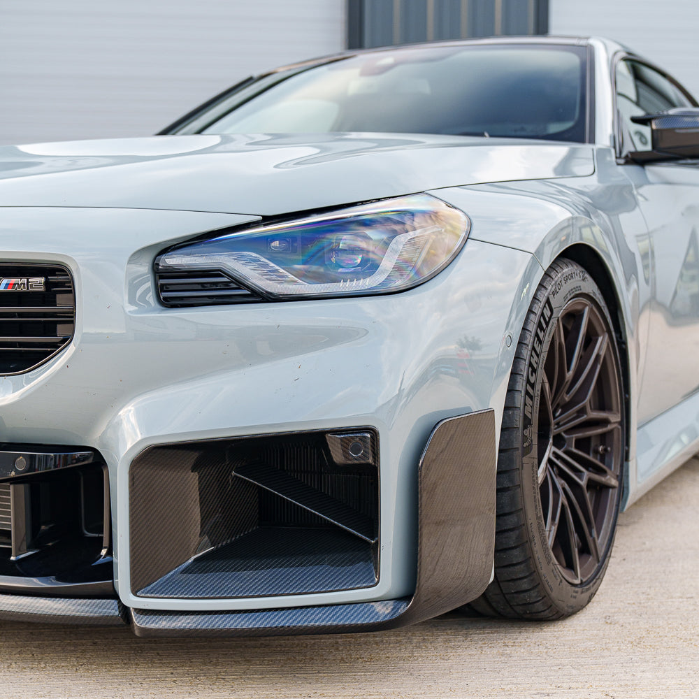 BMW G87 M2 full carbon fiber kit by CT Carbon, including front splitter, side skirts, and rear diffuser, displayed on the car.