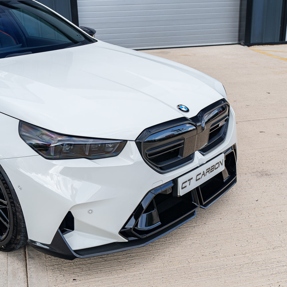 BMW G90 M5 2024 carbon fibre full kit by CT Carbon, featuring sleek exterior components on a black saloon car.
